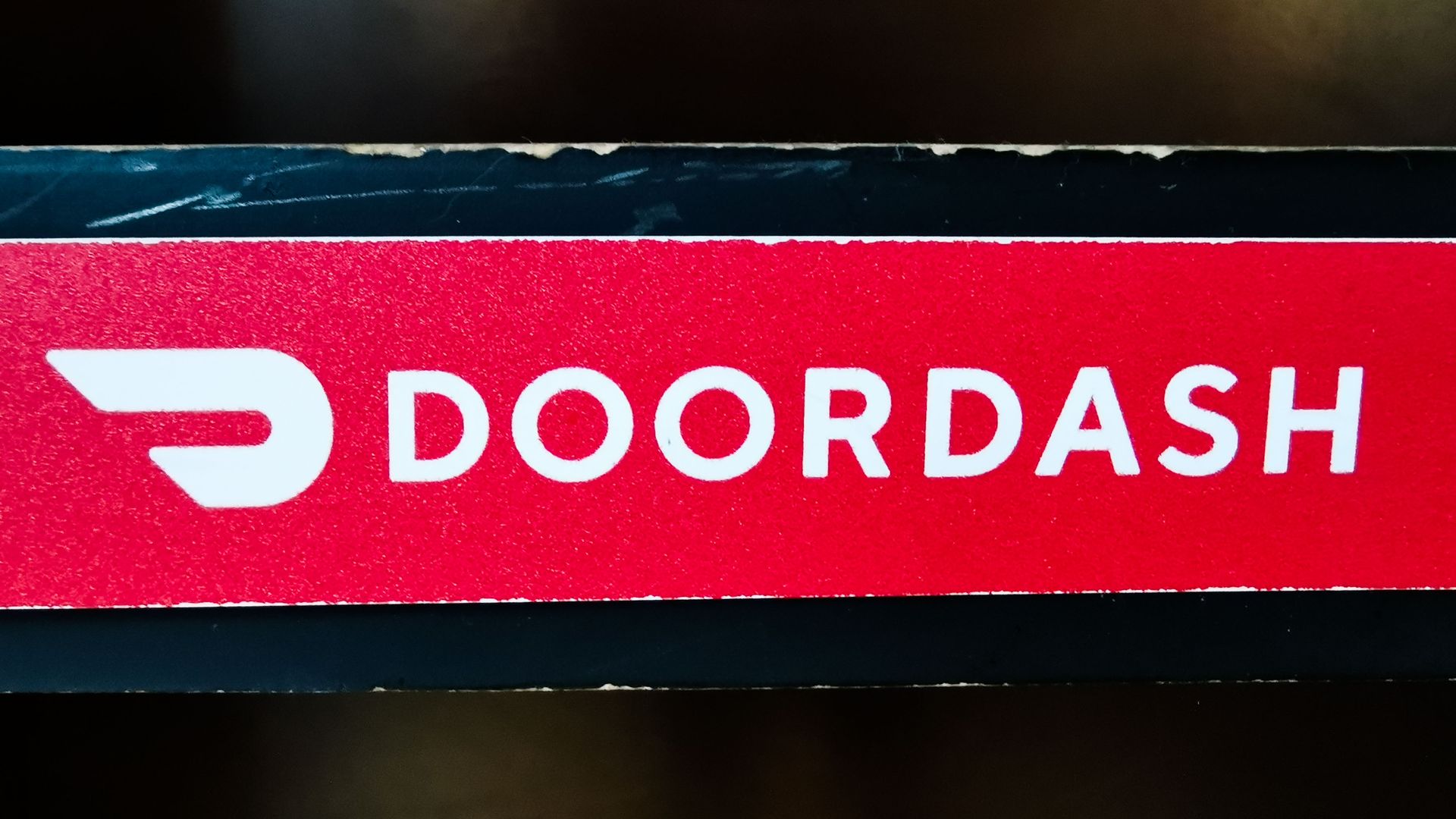 Doordash logo sign is seen in a restaurant in Chicago, United States, on October 17, 2022.