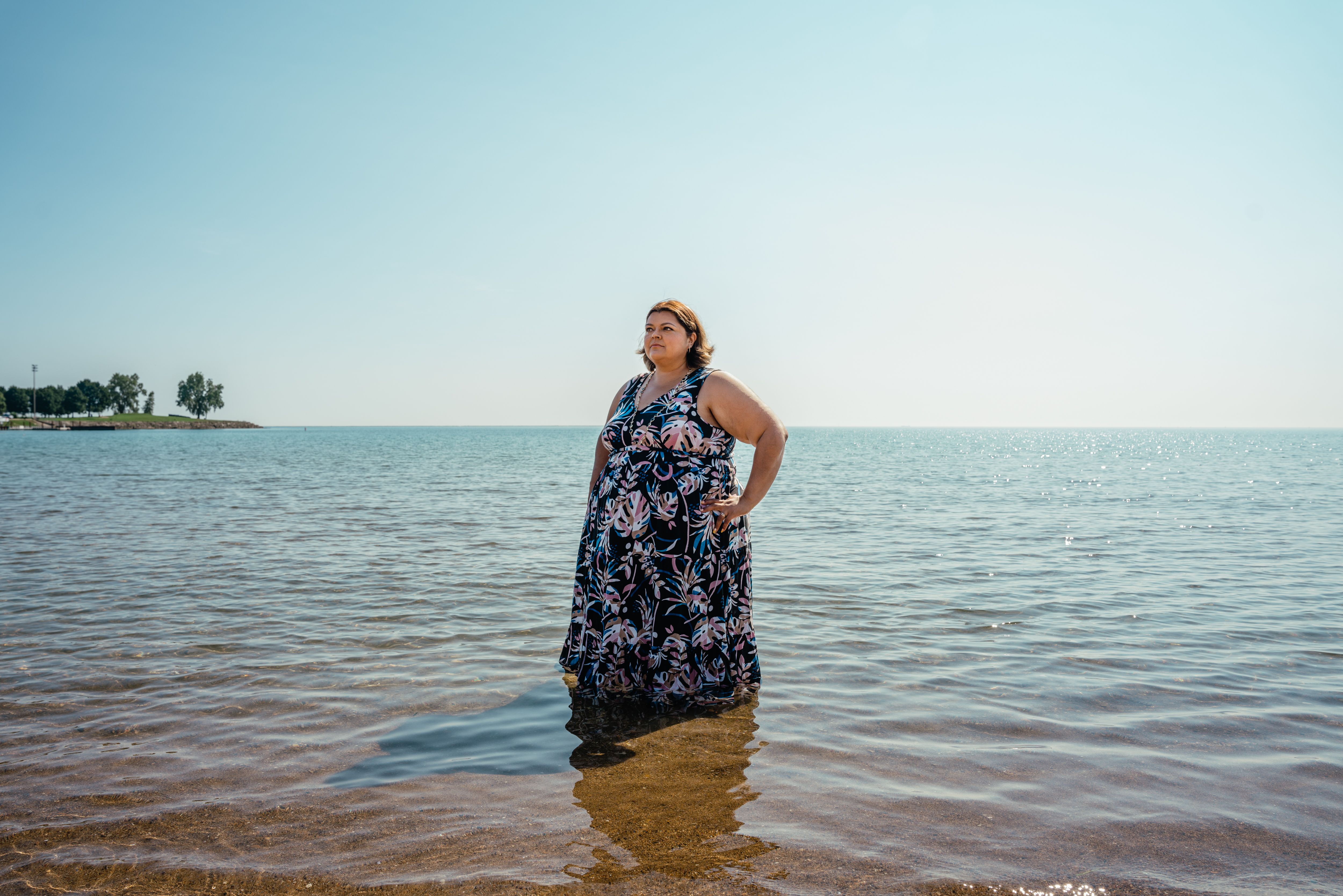 Olga Bautista at Calumet Beach, standing in Lake Michigan in 2021 in a flowing dress