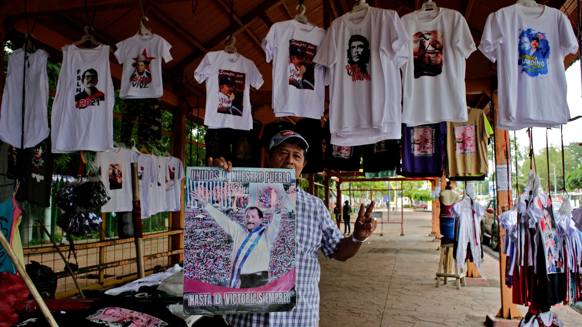 Campaign t-shirts supporting President Daniel Ortega and Vice President/first lady Rosario Murillo hangs in a market stall.