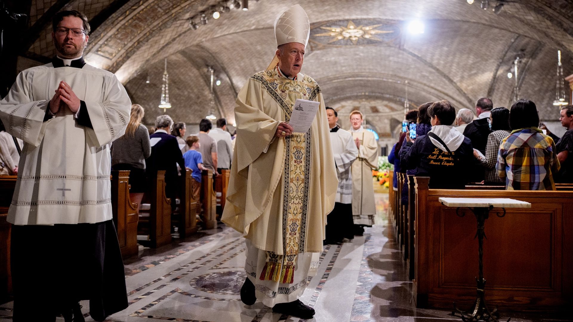 Cardinal Robert McElroy, Archbishop of Washington, walks through the Basilica of the National Shrine of the Immaculate Conception after a mass. 