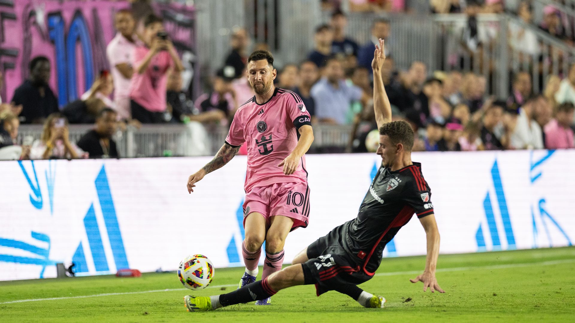 Lionel Messi of Inter Miami CF (1) and Christopher McVey of D.C.United (0) during a MLS League game