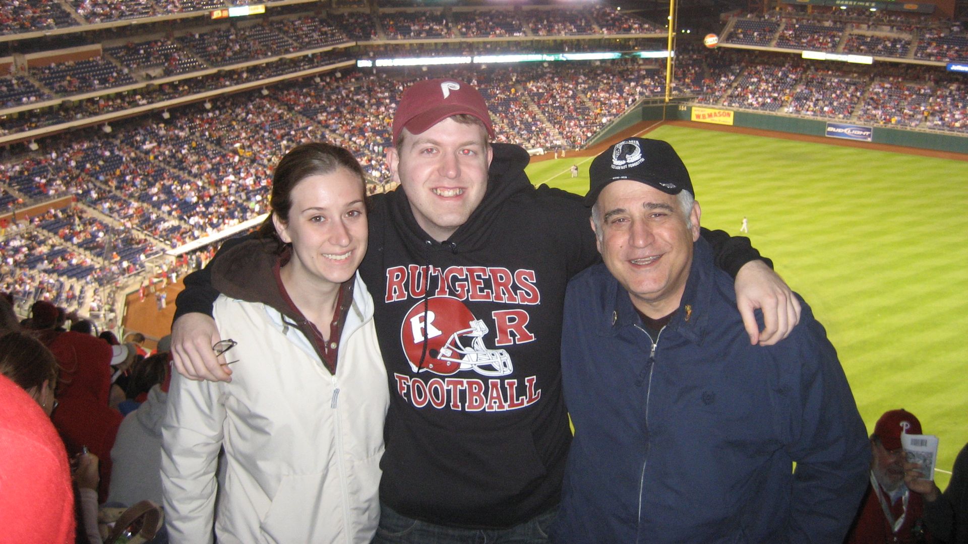 Three people, including Houston meteorologist Matt Lanza, pose for a photo at the Philadelphia Phillies ballpark