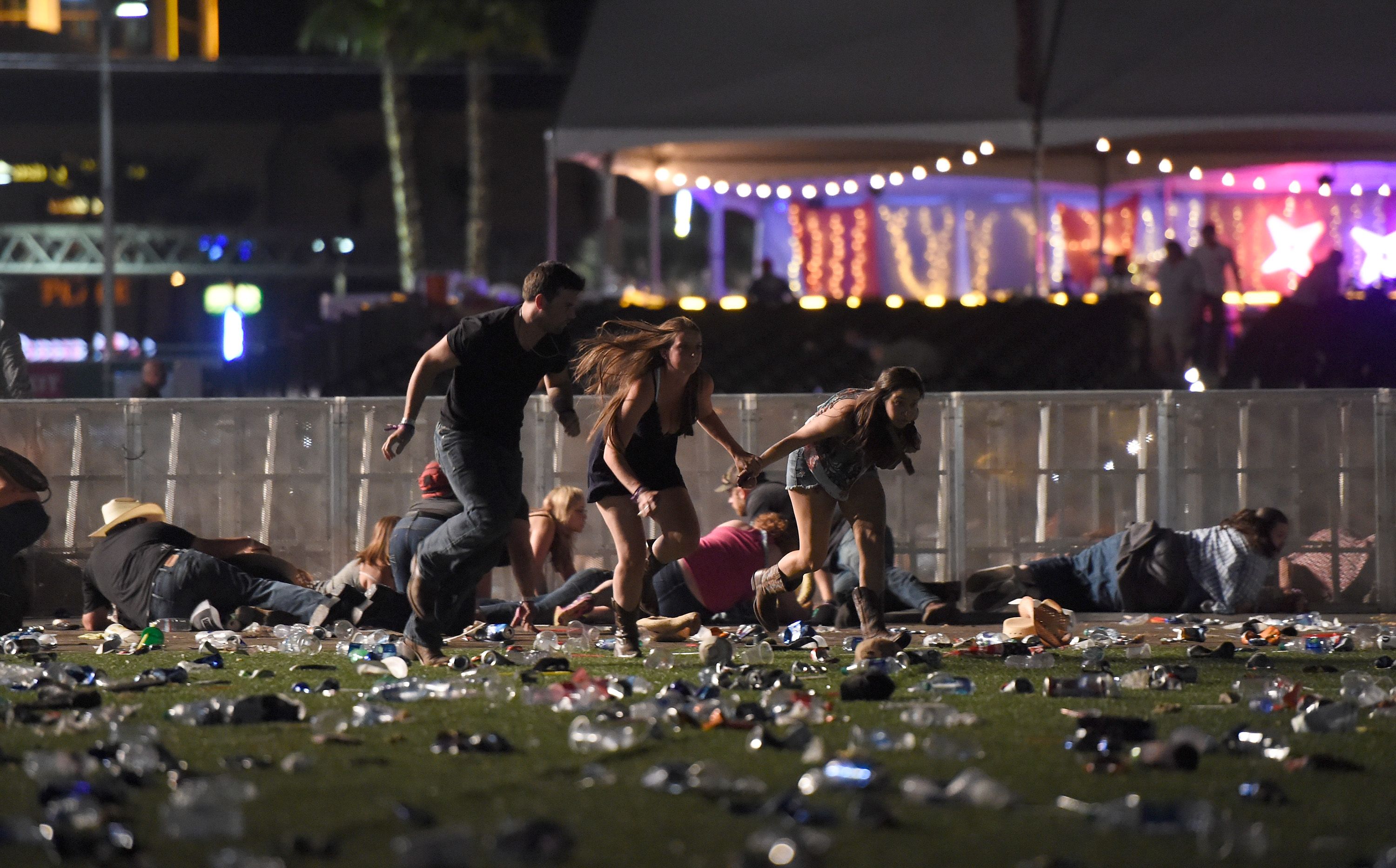 People run from the Route 91 Harvest country music festival after apparent gun fire was heard on October 1, 2017 in Las Vegas, Nevada.