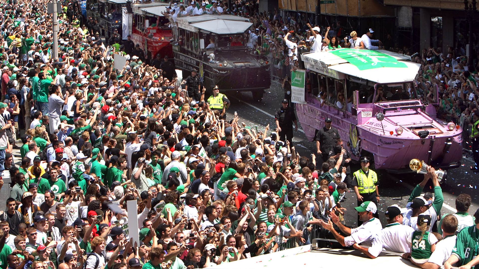 Celtics player Paul Pierce waves his MVP trophy to fans packed along the streets duck boats turn from Tremont Street to Boylston Street in front of the Boston Common during the rolling rally parade to celebrate the Boston Celtics' NBA Championship title in 2008.