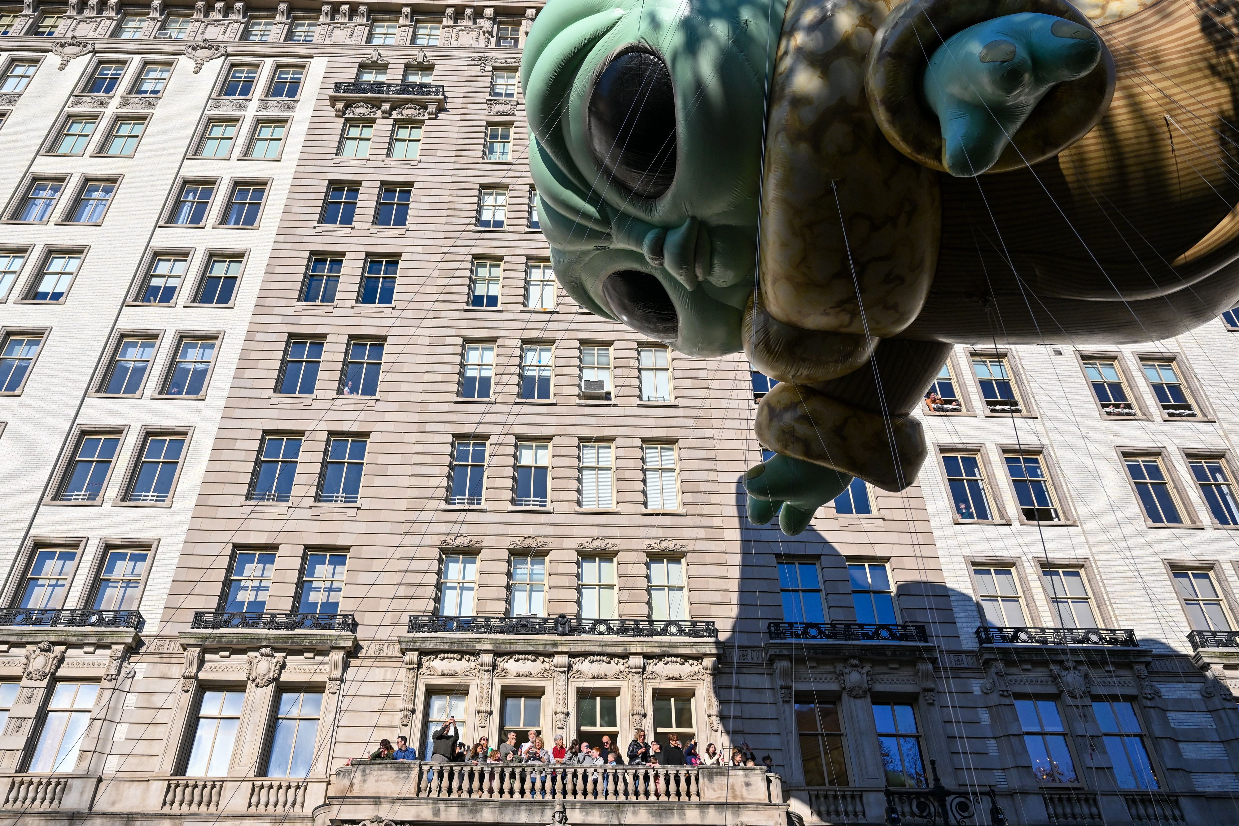 People watch a gigantic Yoda balloon during the Thanksgiving parade