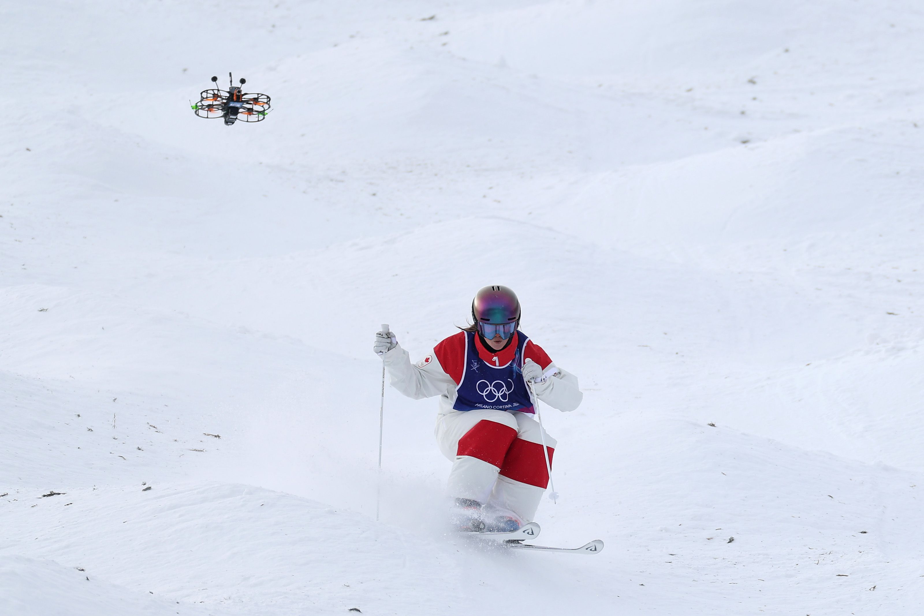 Maia Schwinghammer of Team Canada competes as a drone flies during the Women's Moguls Qualification 1 on day four of the Milano Cortina 2026 Winter Olympic games at Livigno Air Park on February 10, 2026 in Livigno, Italy. (Photo by Cameron Spencer/Getty Images)