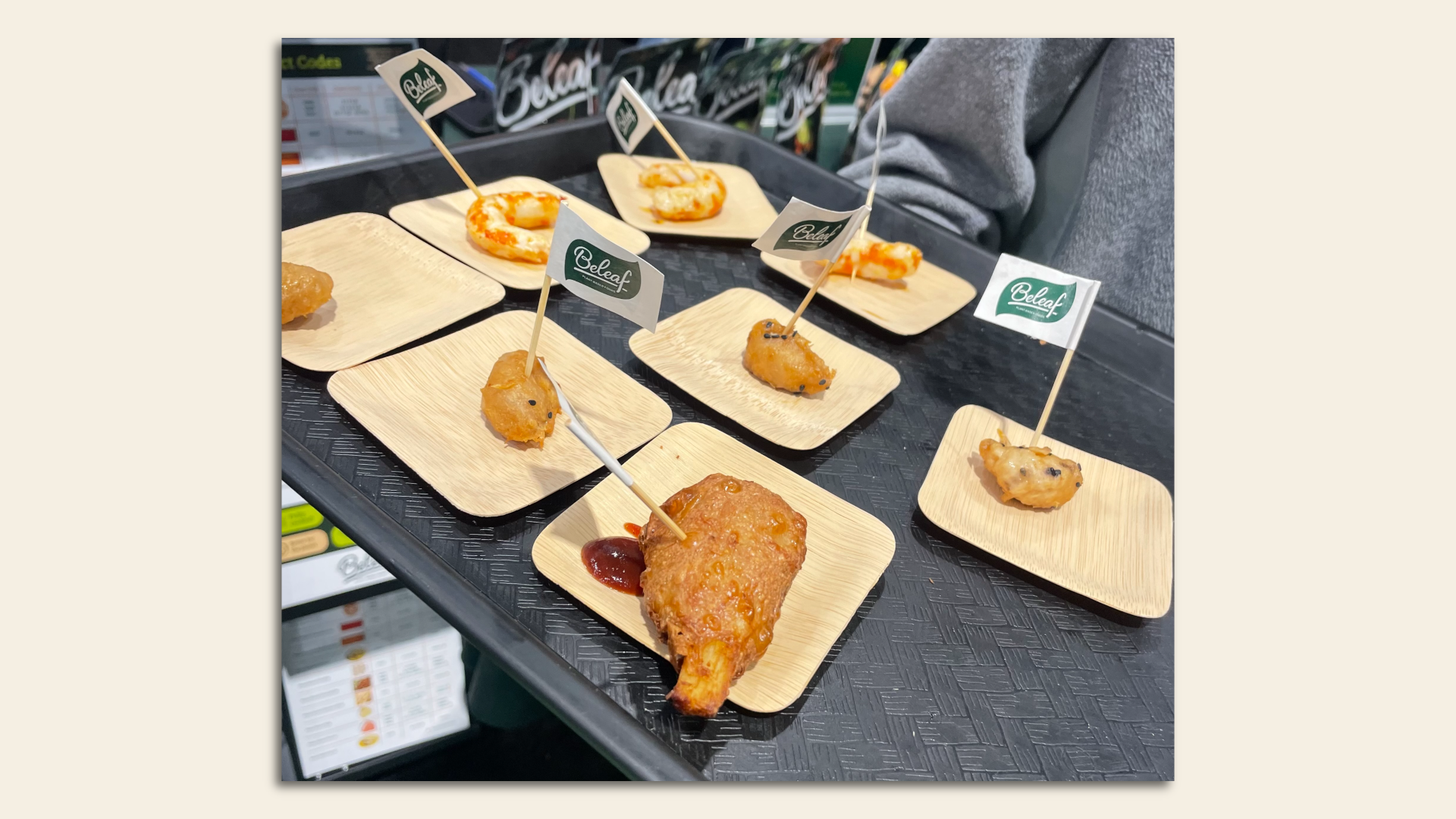An array of vegan fried appetizer bites on individual trays.