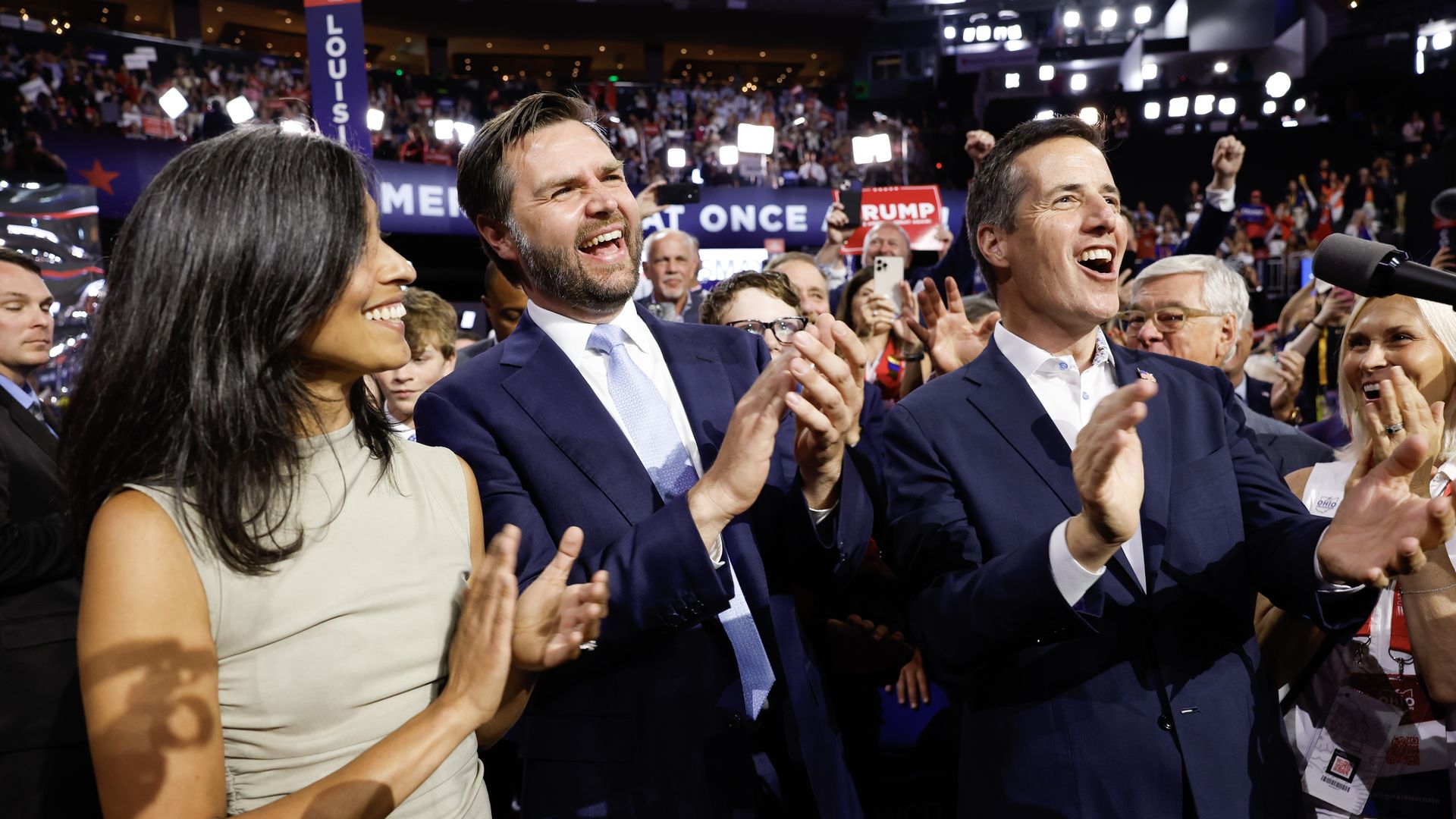 JD Vance, standing on the GOP convention floor flanked by his wife Usha and GOP Senate candidate Bernie Moreno.