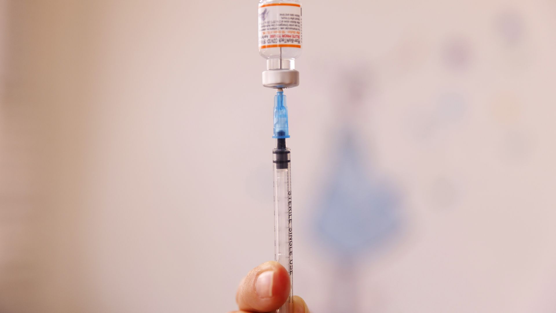 A nurse fills a syringe with a Pfizer-BioNTech Covid-19 vaccine for a child.