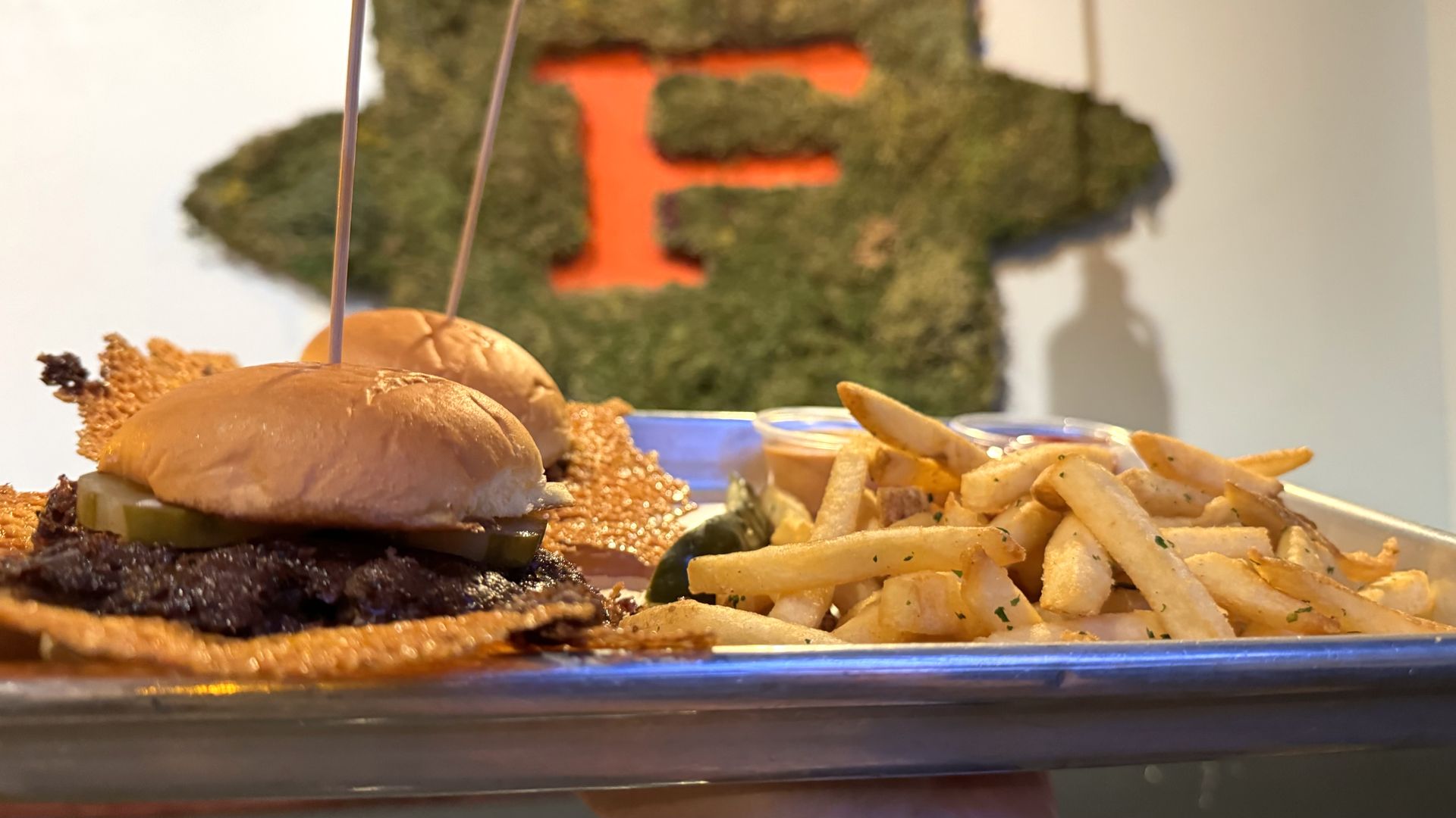 A plate of sliders and fries.