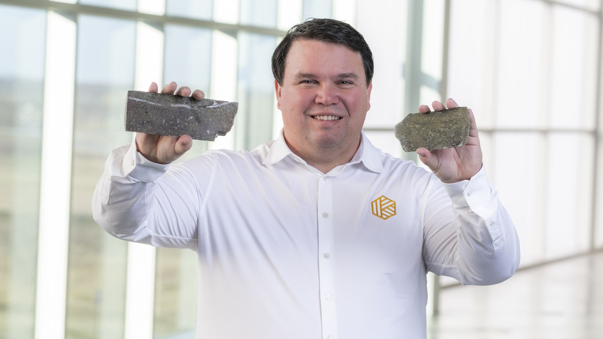 Koloma co-founder Tom Darrah holding up iron-rich rocks