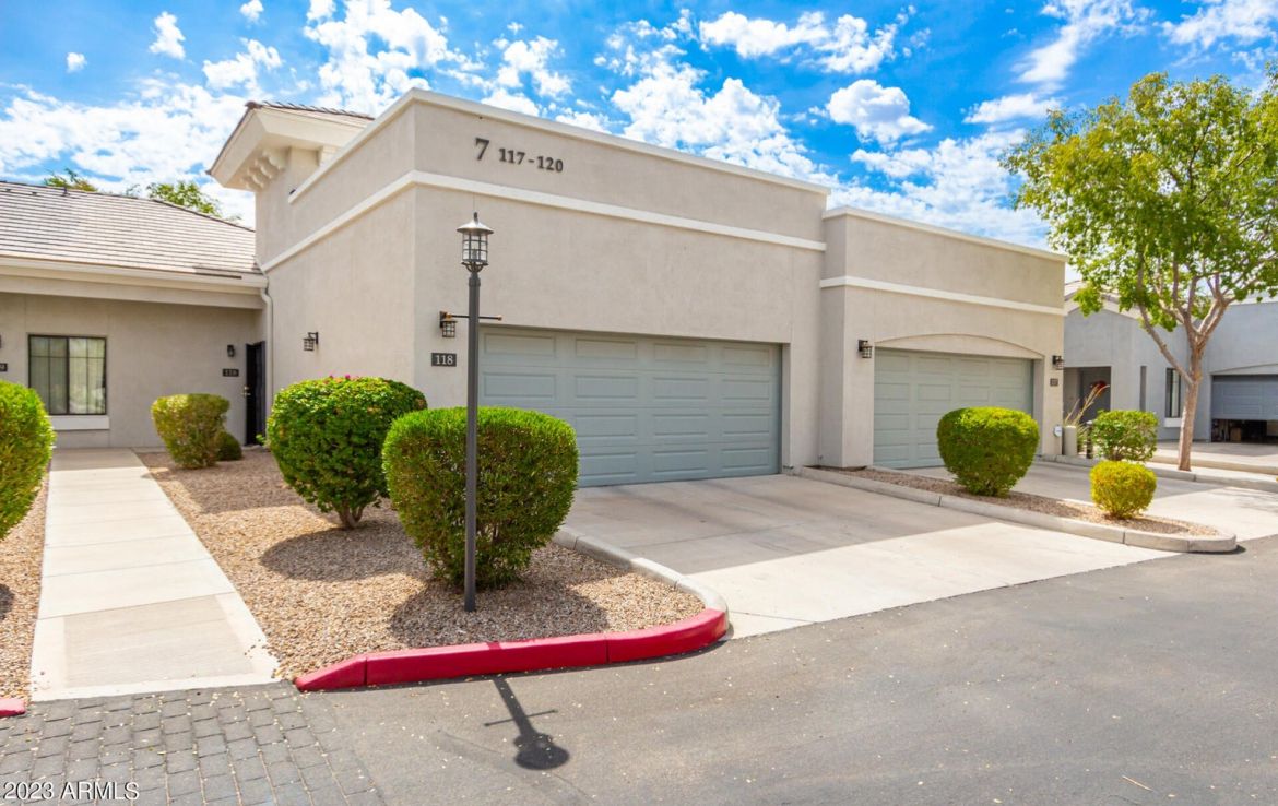 A townhome with a blue garage.