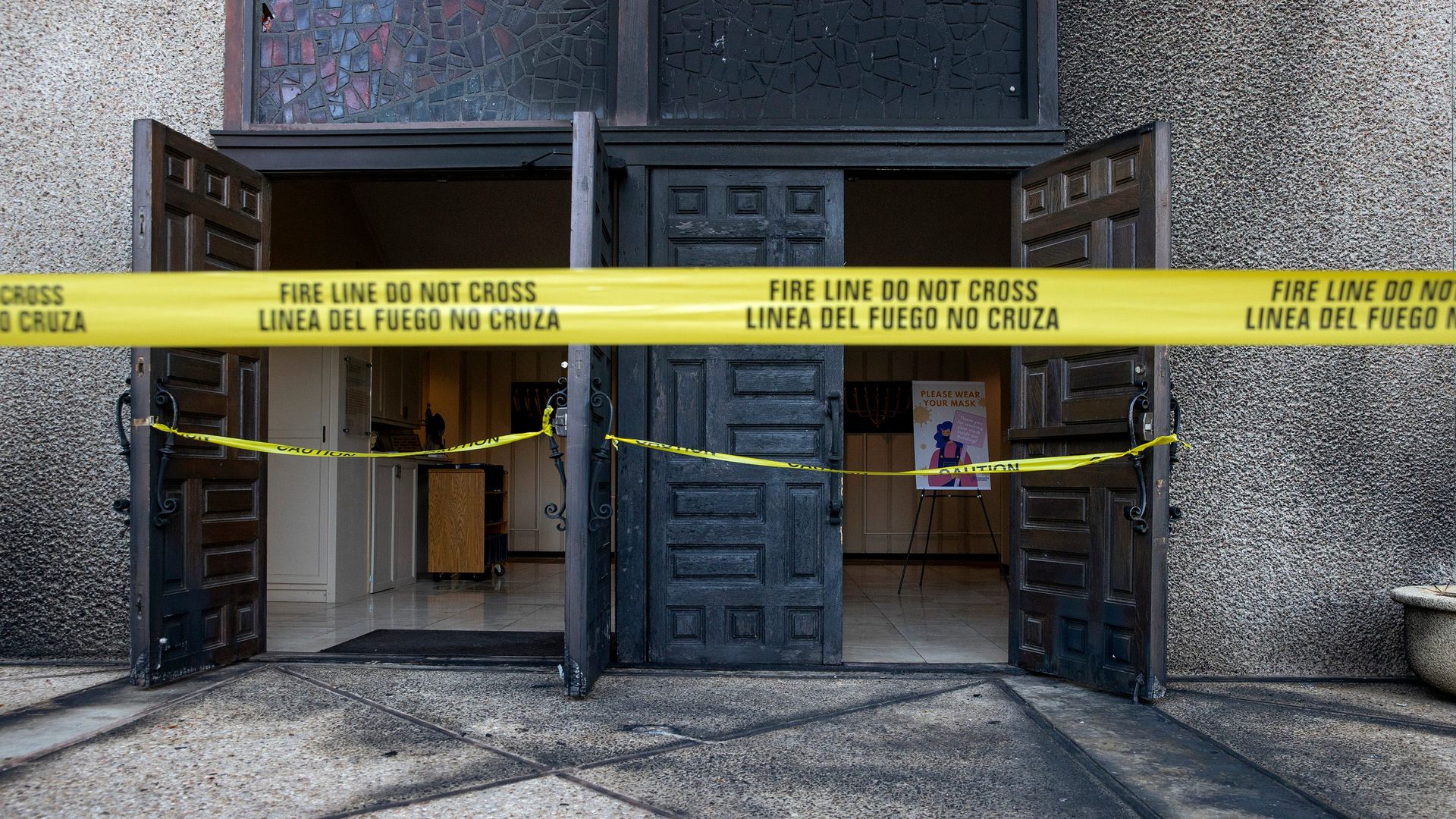 The charred front doors of Congregation Beth Israel in Austin.