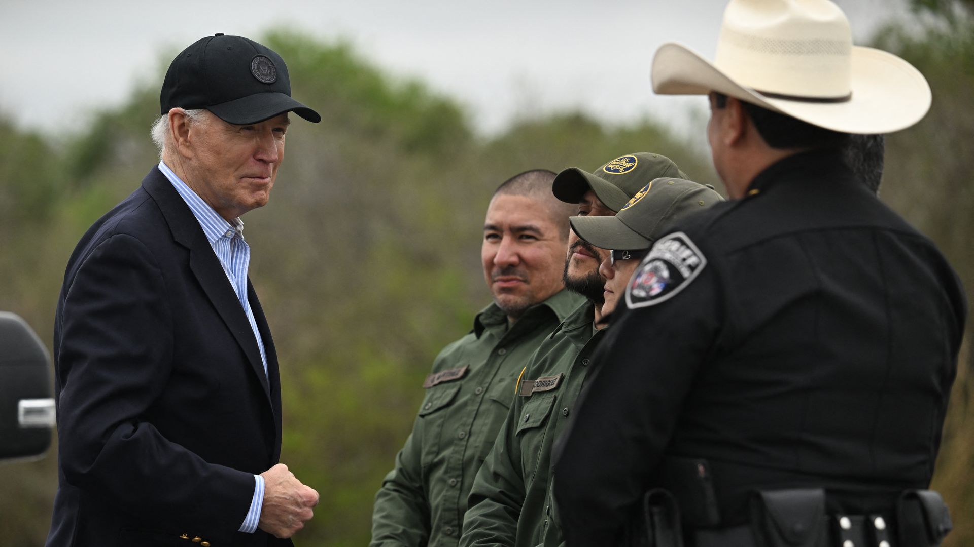 President Joe Biden (L) speaks with US Border Patrol agents as he visits the US-Mexico border in Brownsville, Texas, on February 29, 2024. 
