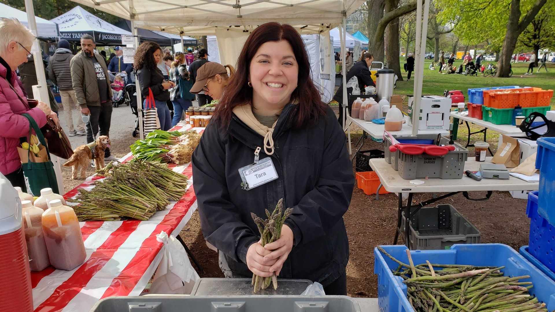 Photo of a woman holding asparagus at a farmers market