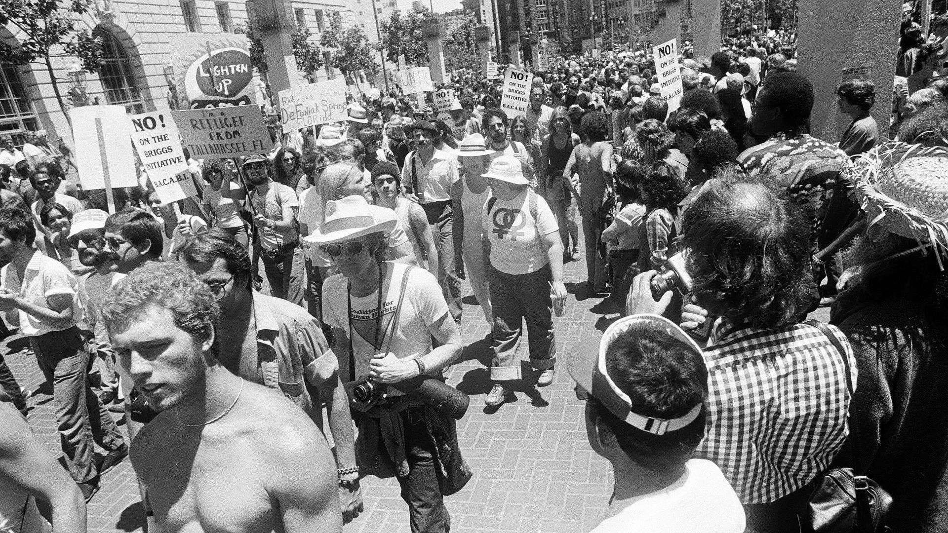 Photo of marchers holding placards advocating for gay rights at a parade