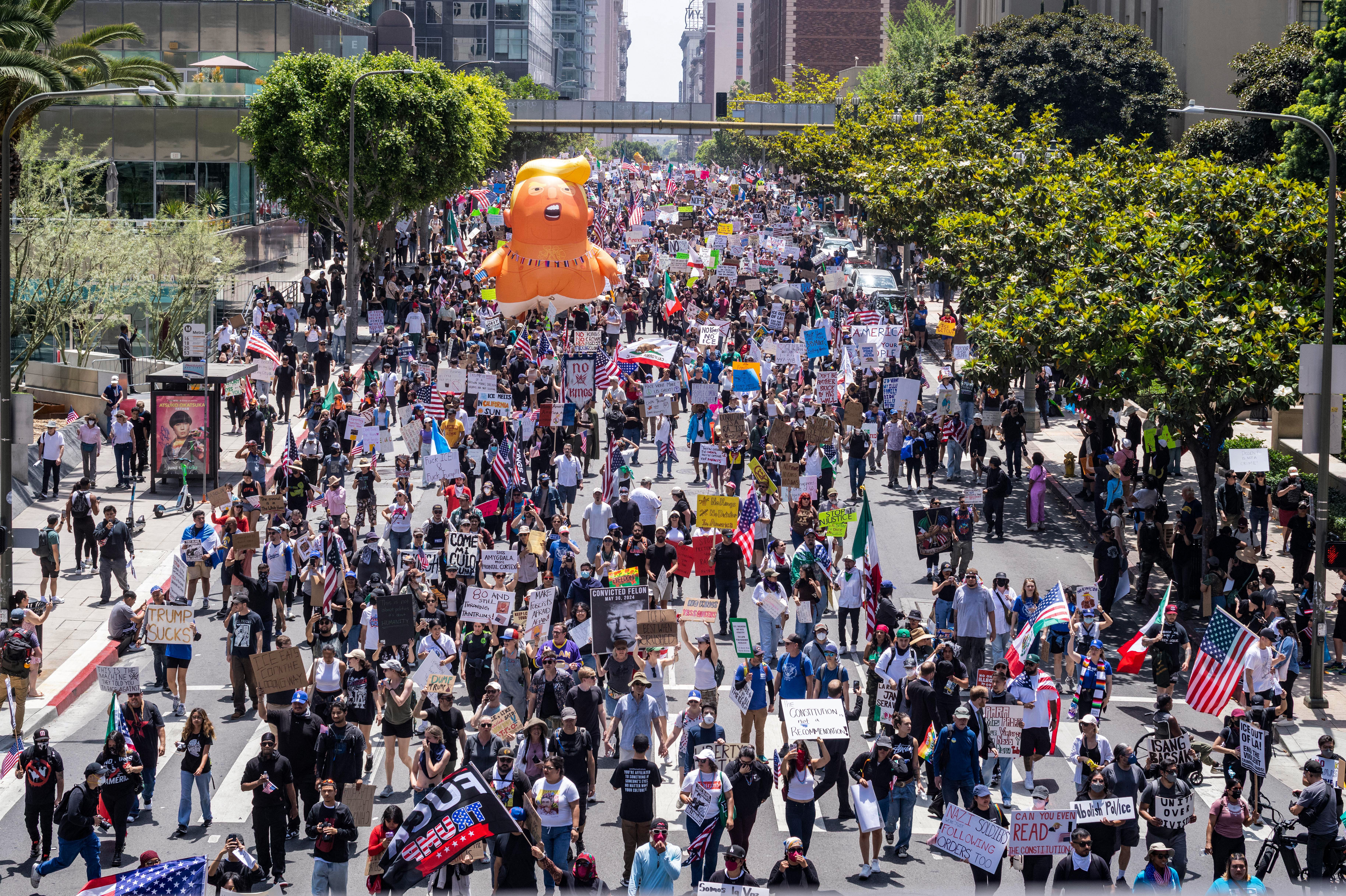 Protesters in Los Angeles march with ​a Trump baby ⁣balloon during a nationwide 'No Kings' rally.