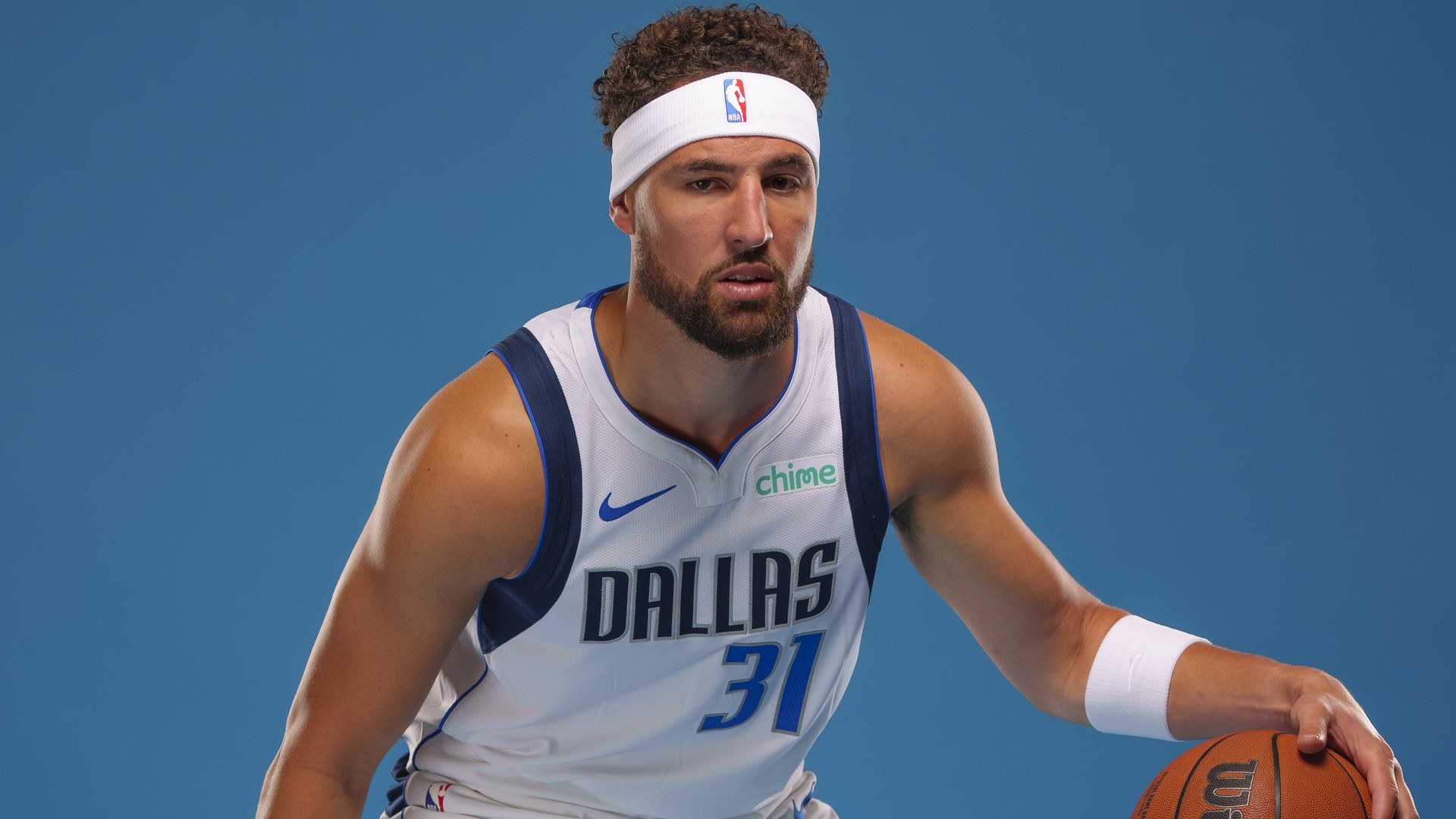A photo of Klay Thompson in a Dallas Mavericks jersey about to dribble a ball 