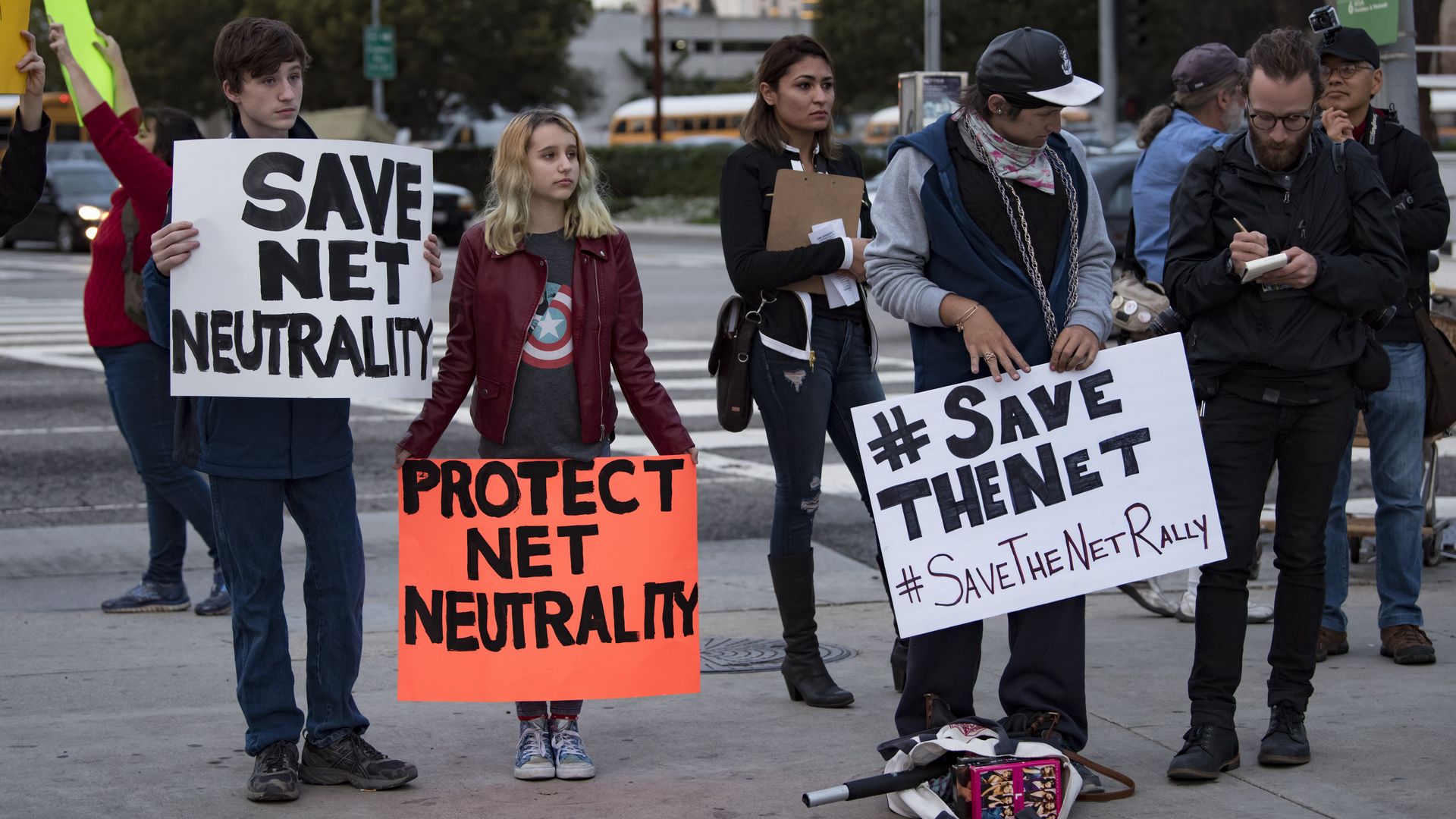 Protesters with signs against repealing net neutrality 