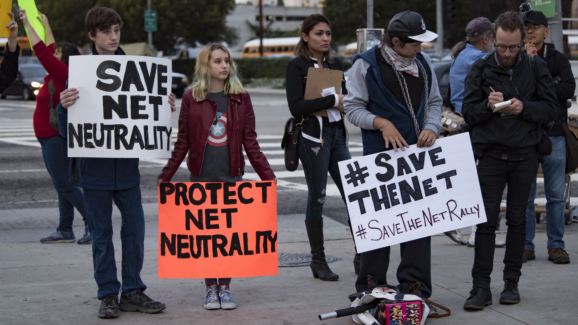 Protesters with signs against repealing net neutrality