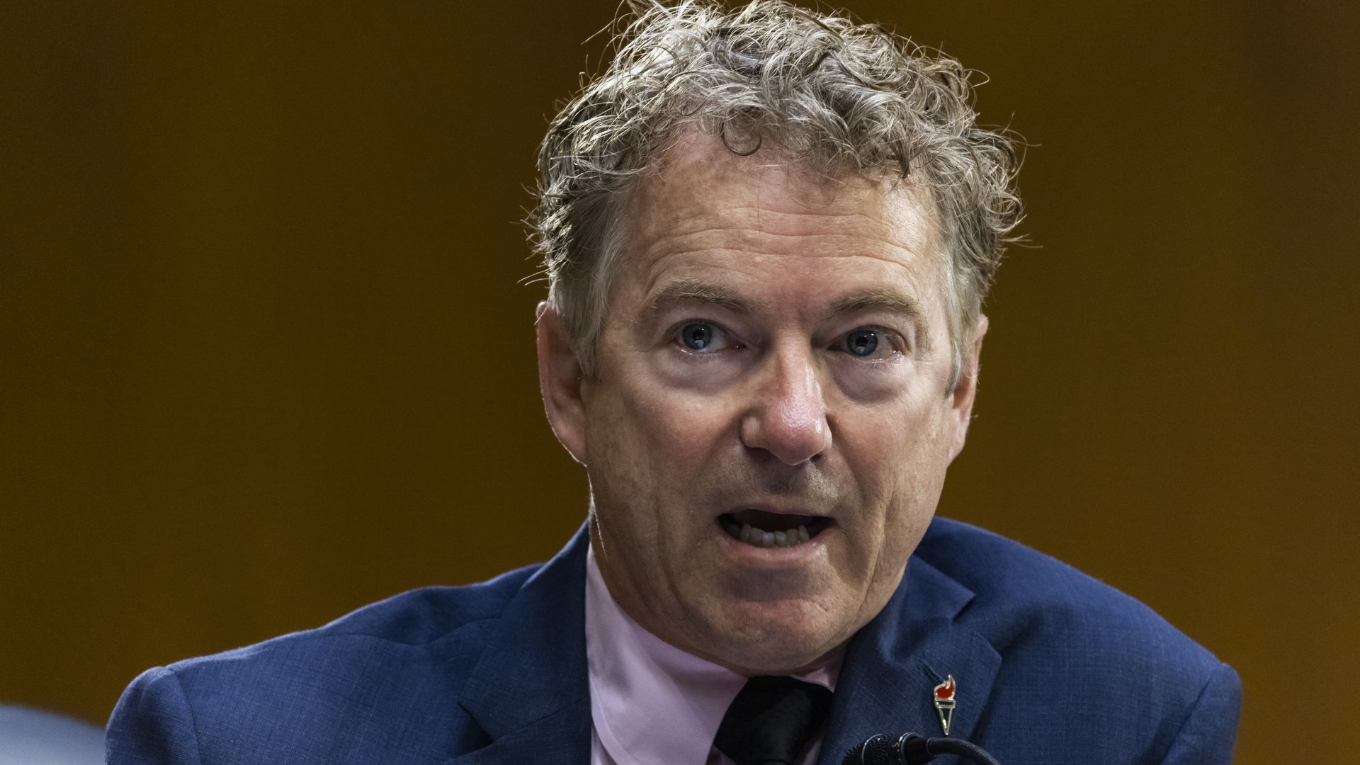 Rand Paul wears a suit and tie 