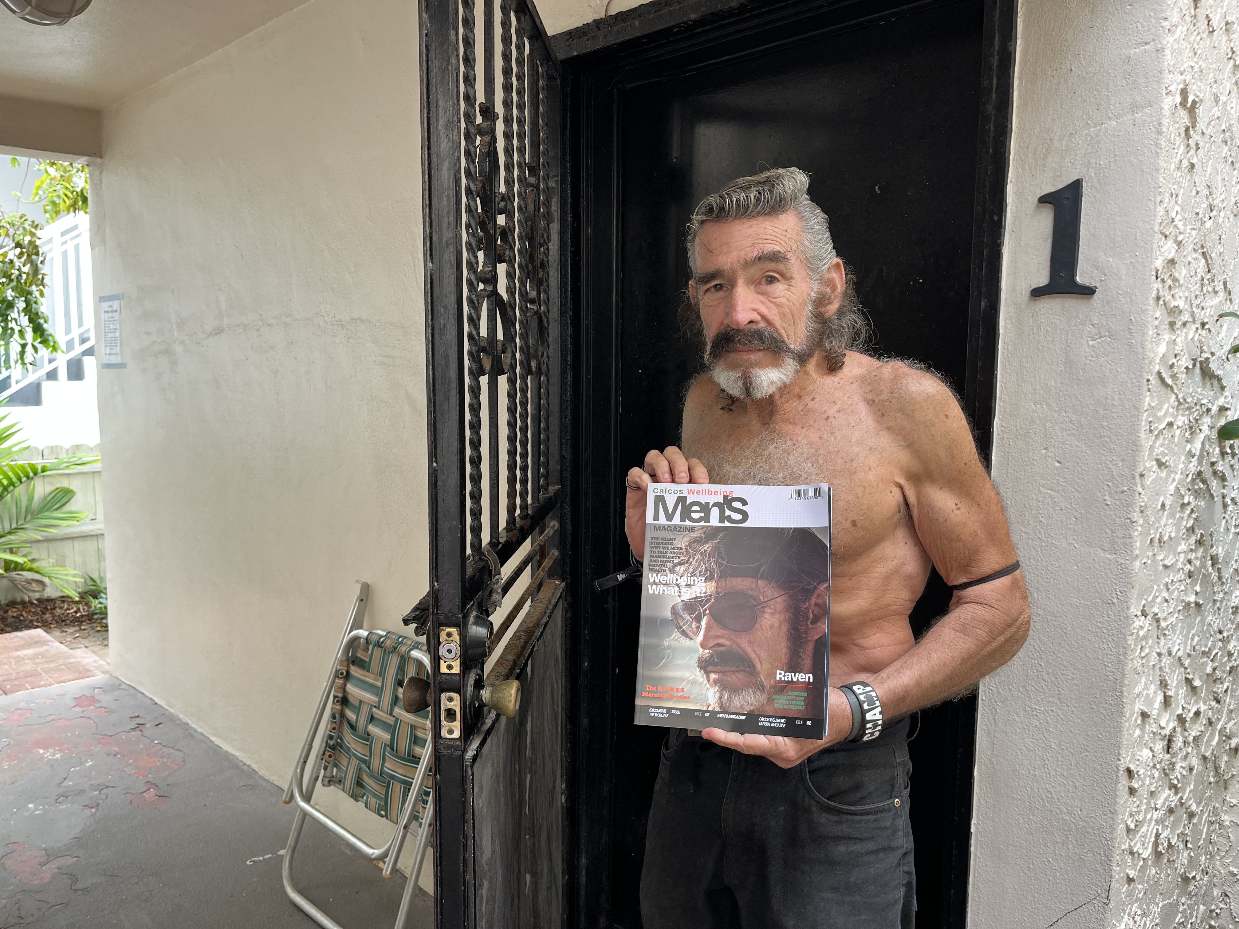 Robert "Raven" Kraft poses with a magazine cover.