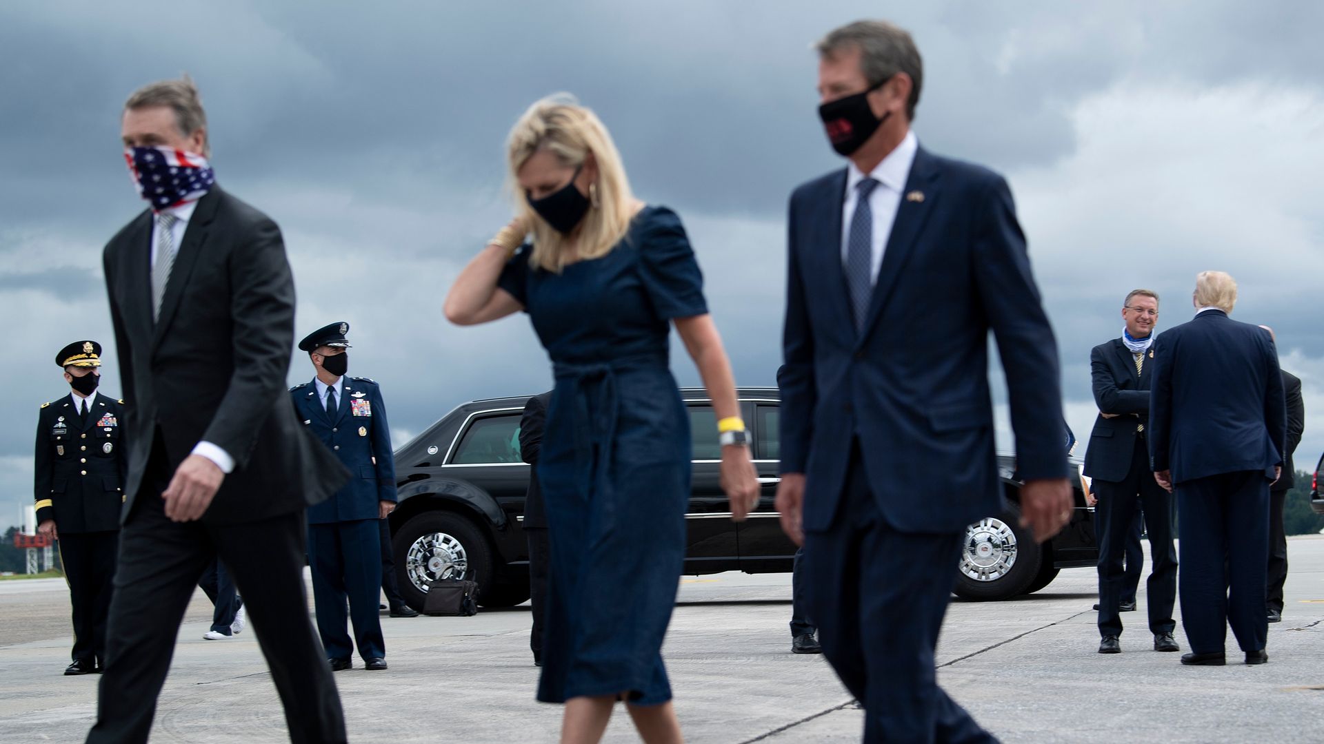 David Perdue, Marty Kemp and Brian Kemp walking on tarmac in masks