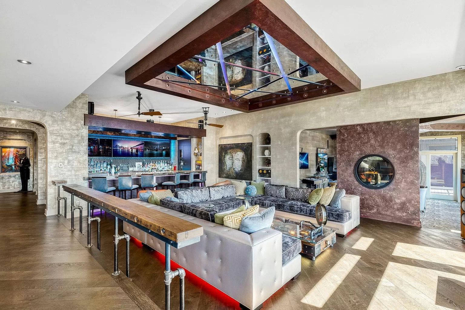 A living room with a mirrored ceiling and zebra couch.