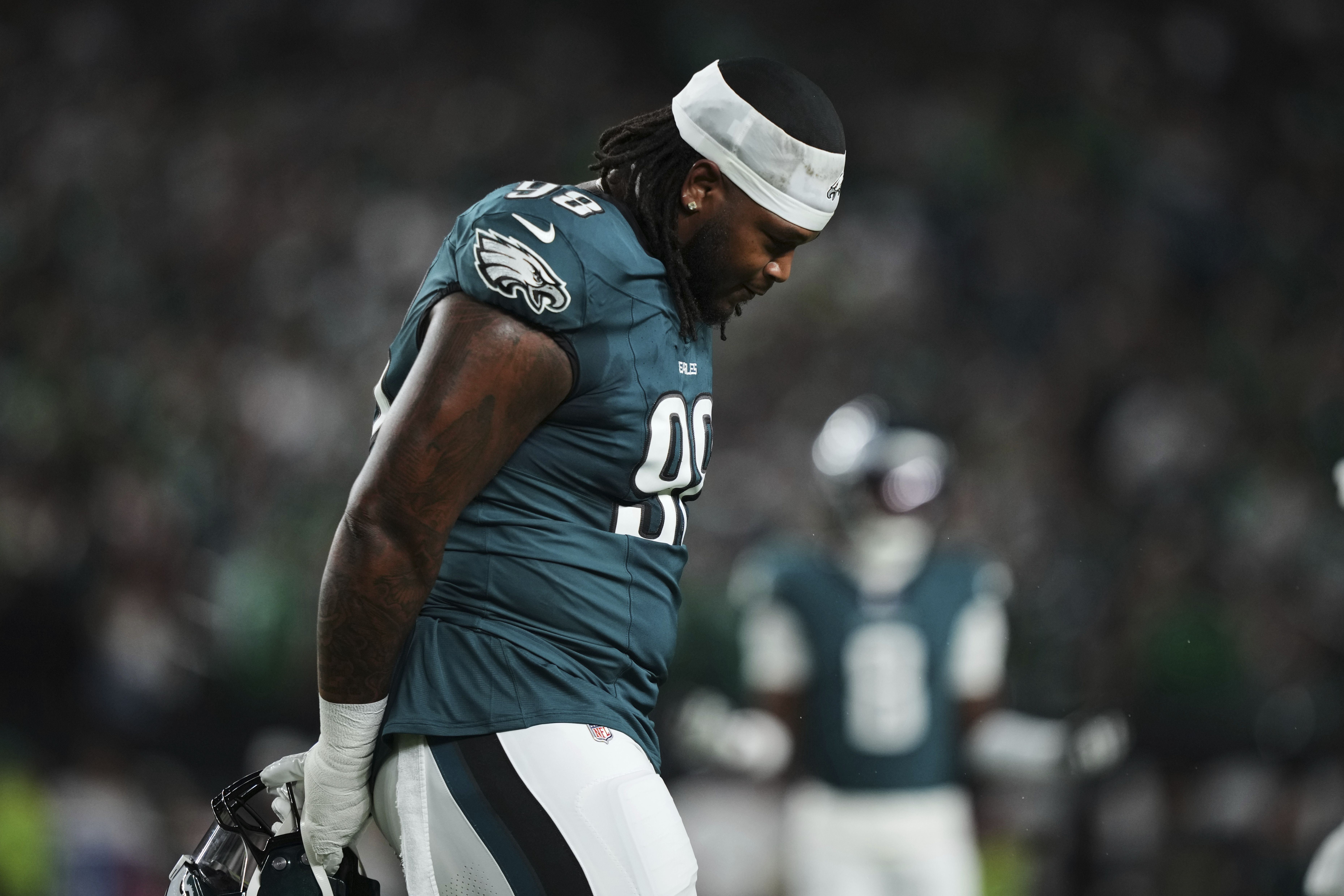 Philadelphia Eagles defensive tackle Jalen Carter walks off the field after being disqualified for unsportsmanlike conduct.