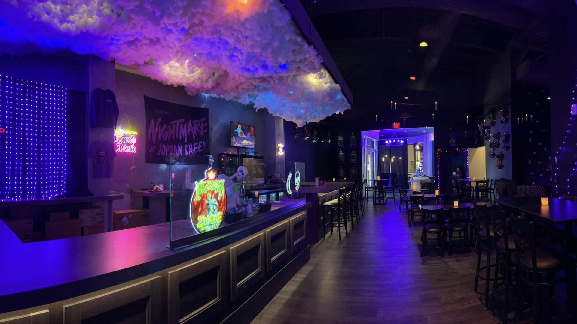 A bar with cool clouds and purple lighting