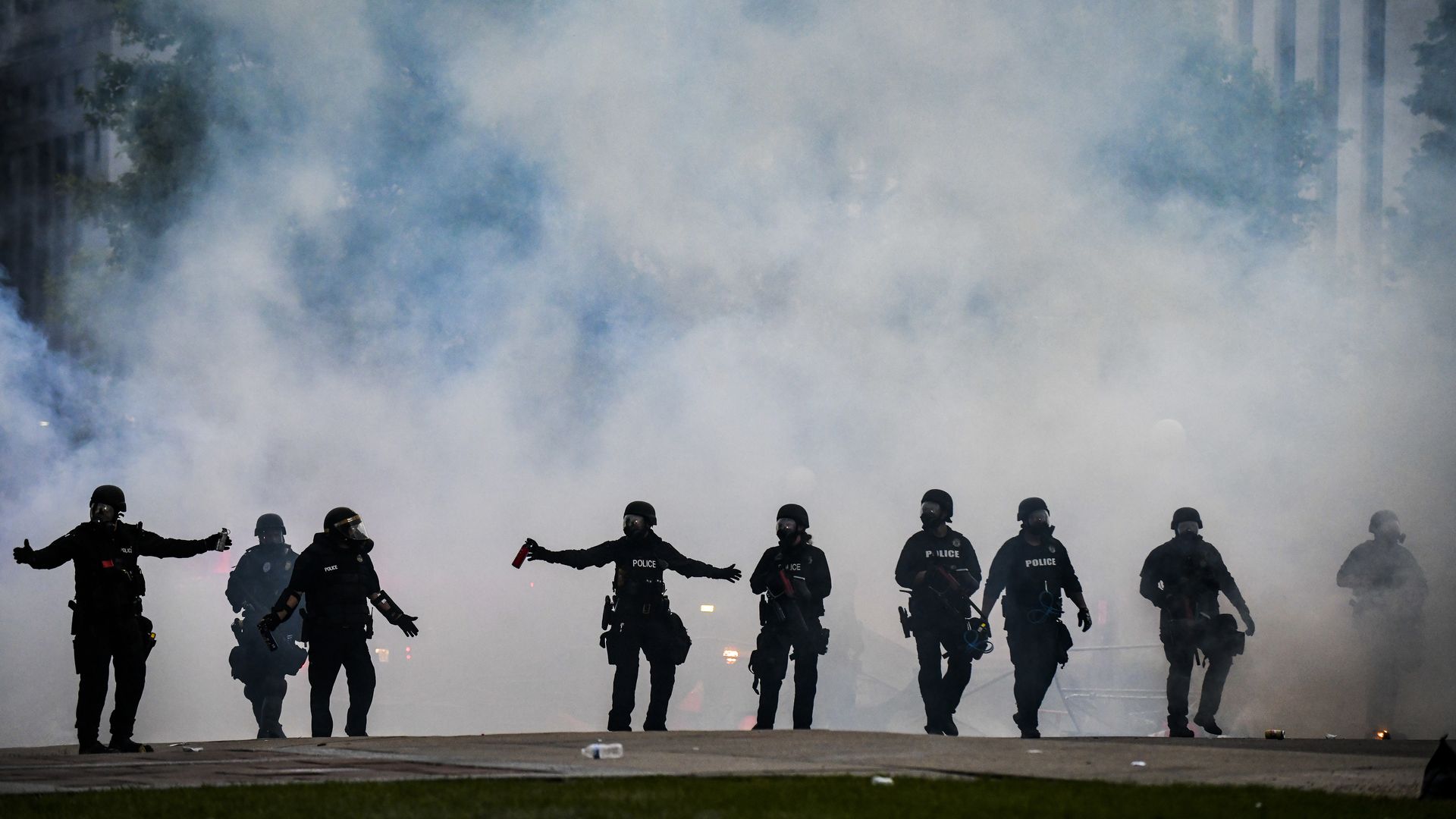 Police officers walk through a cloud of tear gas as they try to disperse people protesting in Denver on May 30, 2020. Photo: Michael Ciaglo/Getty Images