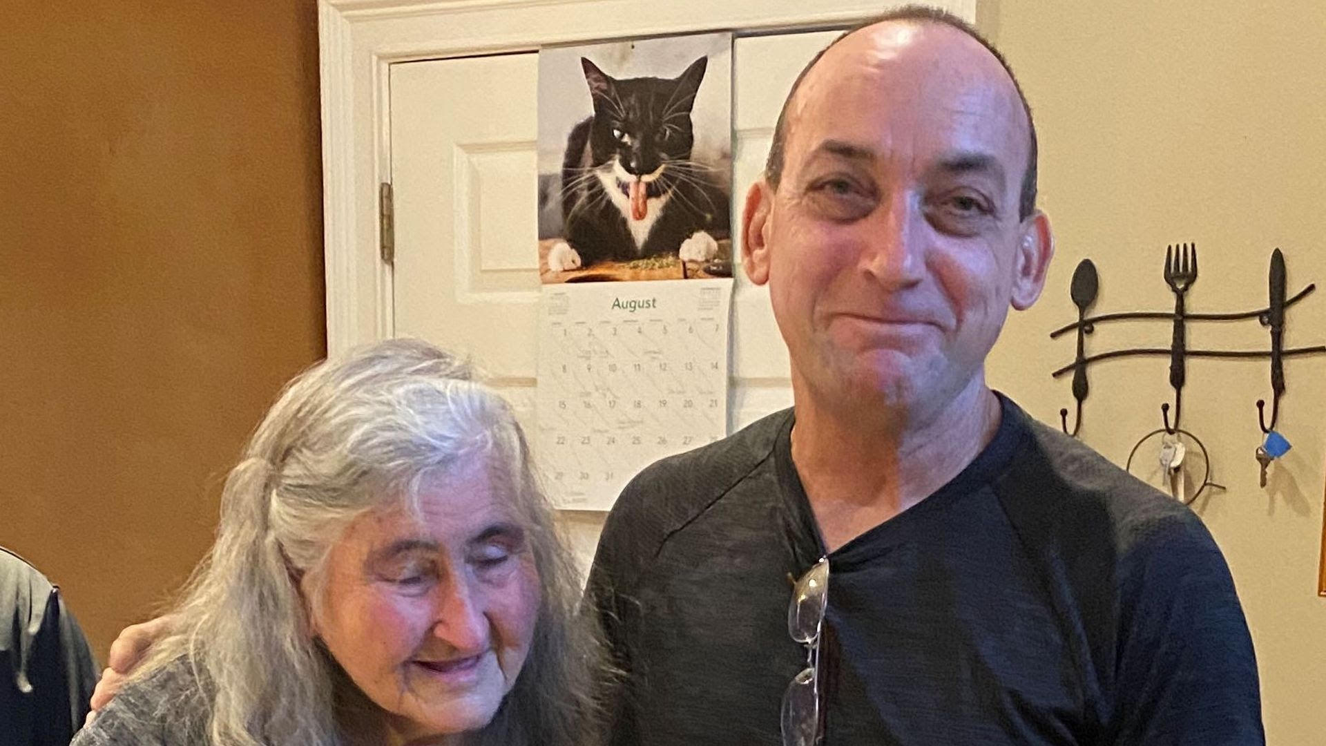 Robert DuBoise (right) stands with his arm around his mother, Myra DuBoise.