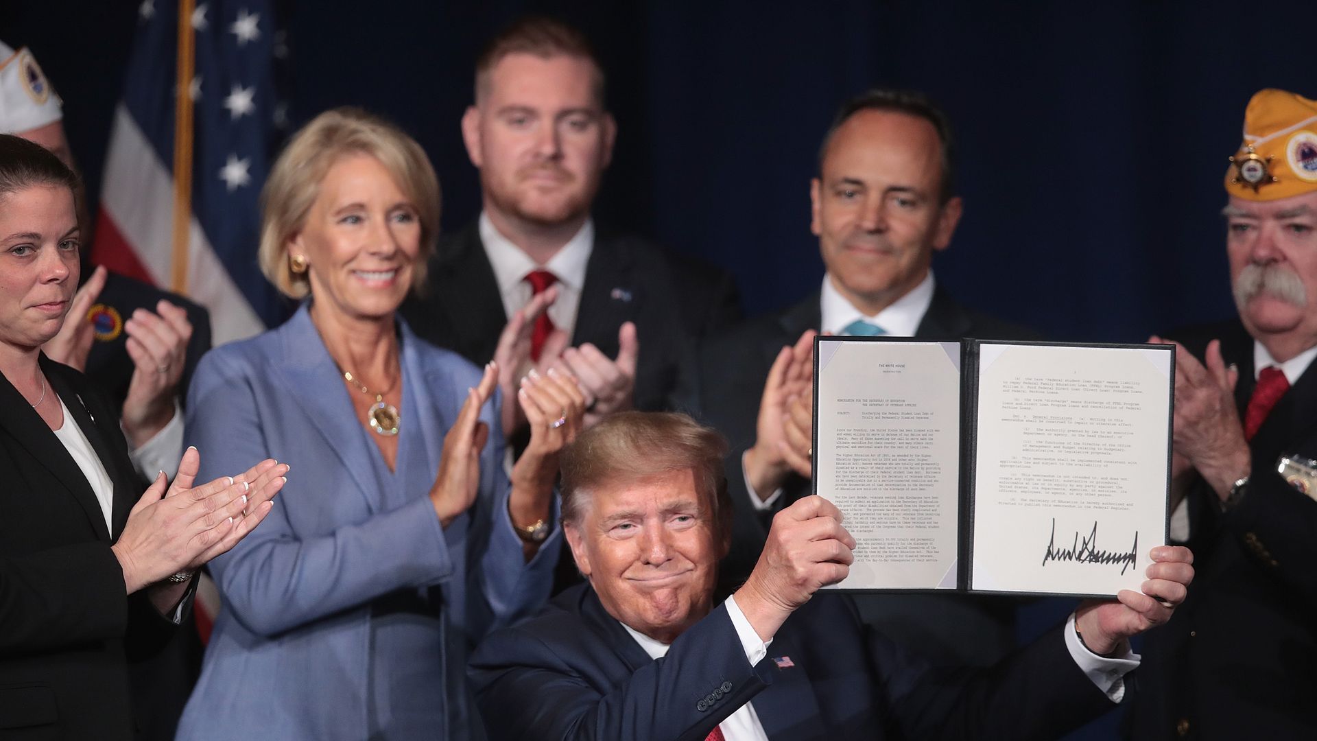 President Donald Trump signs a proclamation that will eliminate student loan debt for qualifying disabled veterans following a speech at the American Veterans