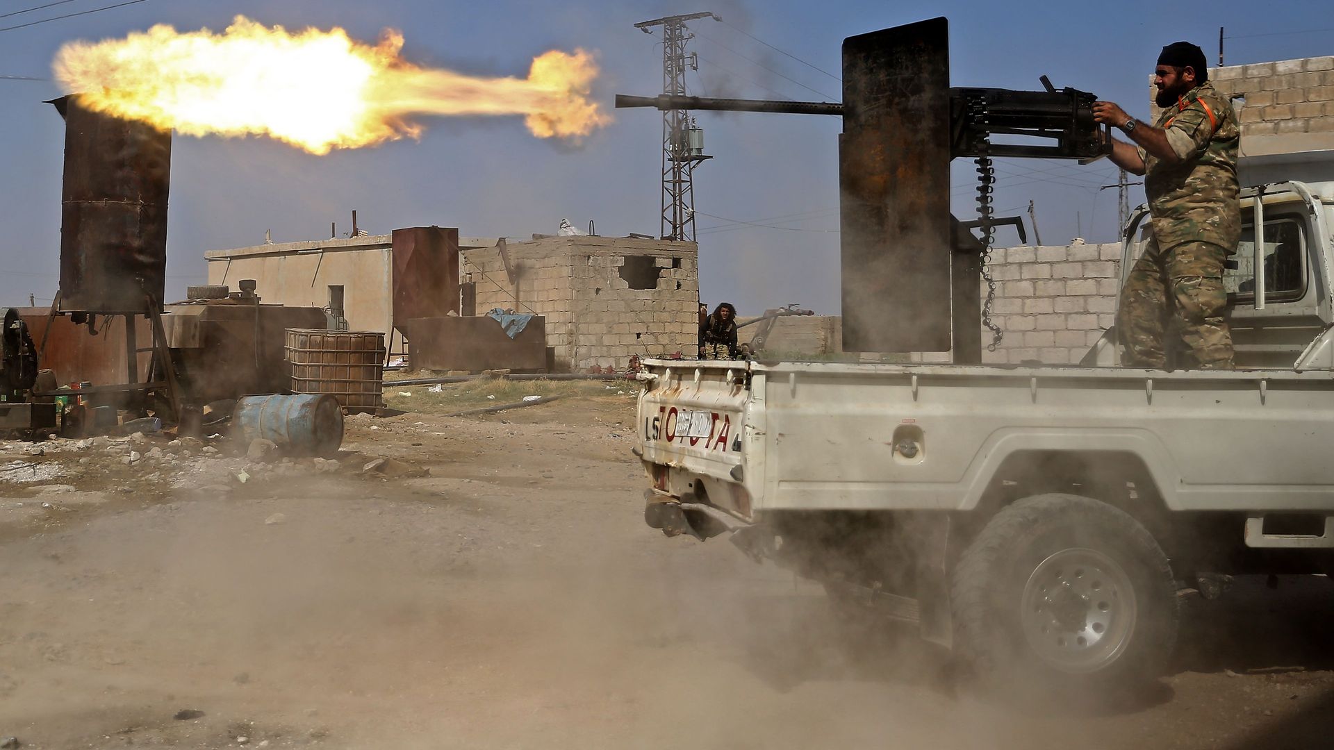Turkish-backed Syrian fighters fight in the border town of Ras al-Ain on October 13, 2019.