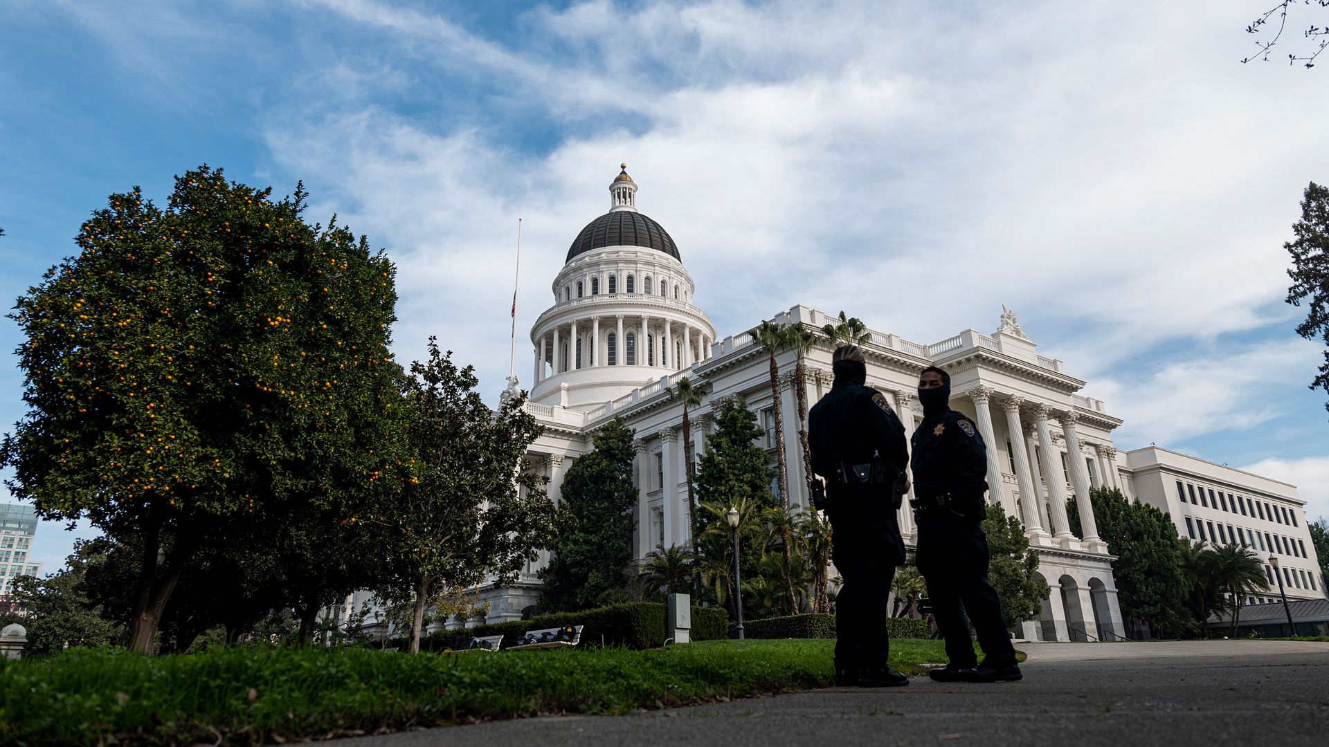 Members of the California Highway Patrol (CHP) wearing protective masks stand outside the California State Capitol building in Sacramento, California, U.S., on Friday, Jan. 15, 2021.