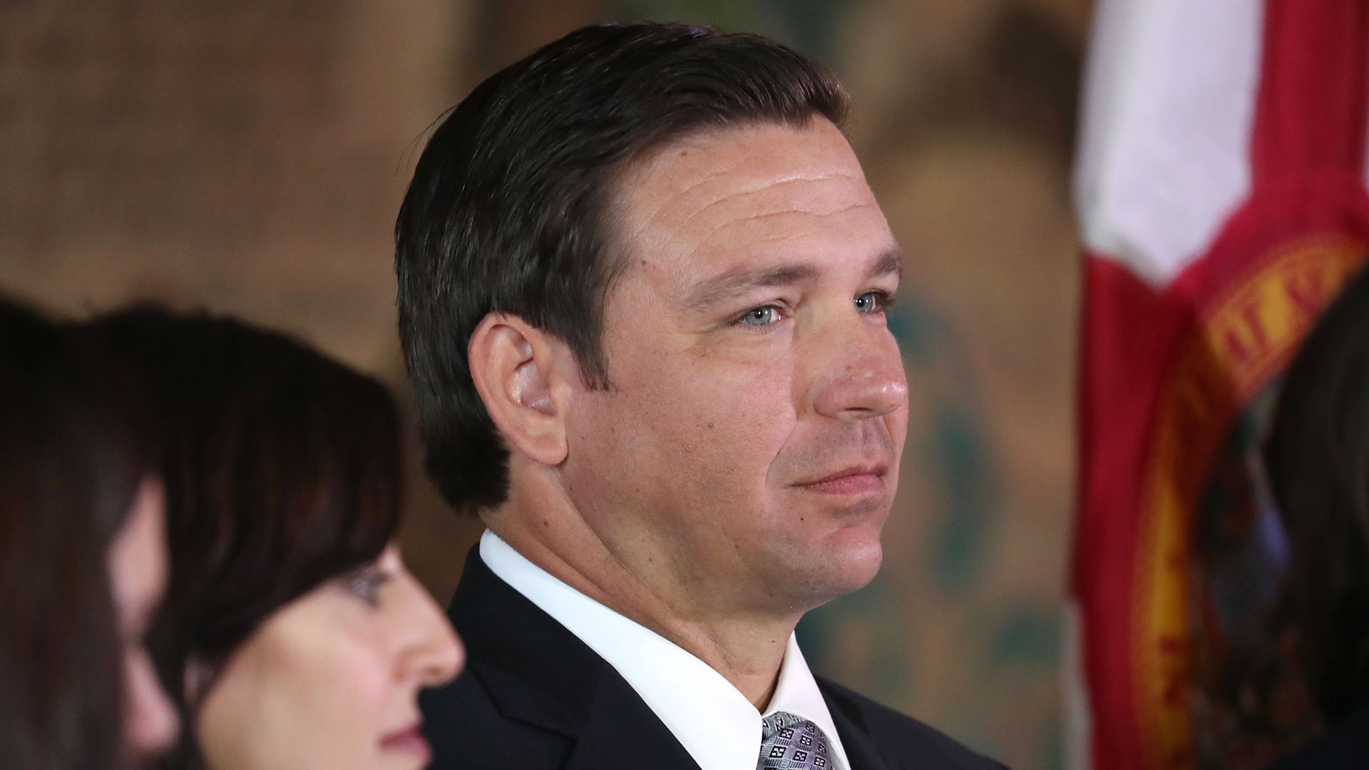 This image is a side profile of Ron DeSantis wearing a suit.