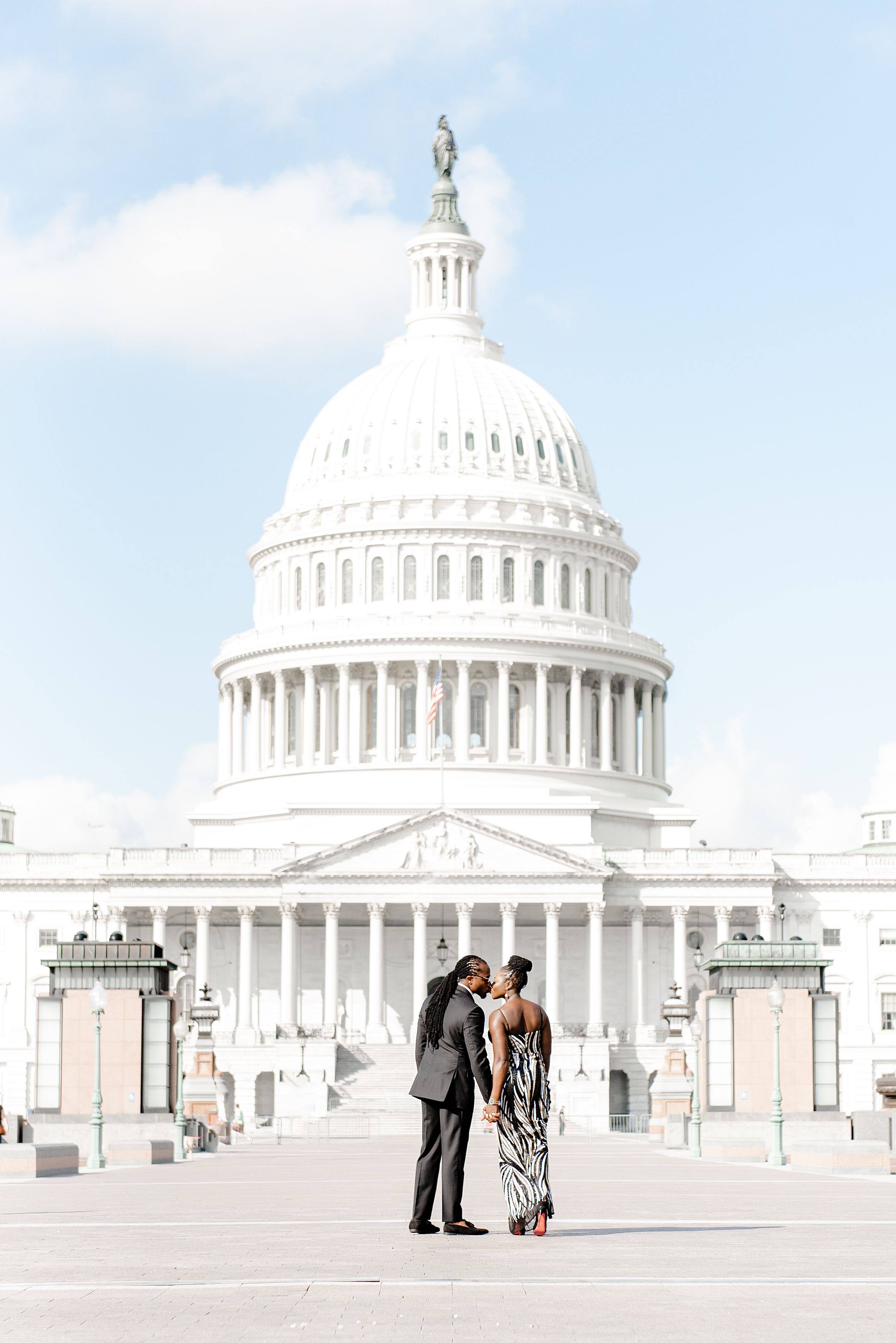 A couple kisses outside of the Supreme Court.