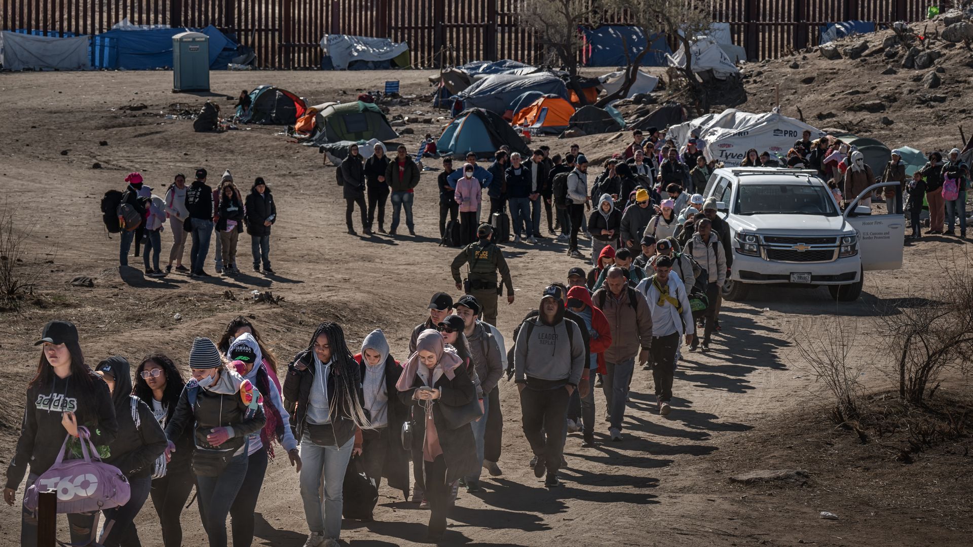 A line of migrants at the U.S.-Mexico border