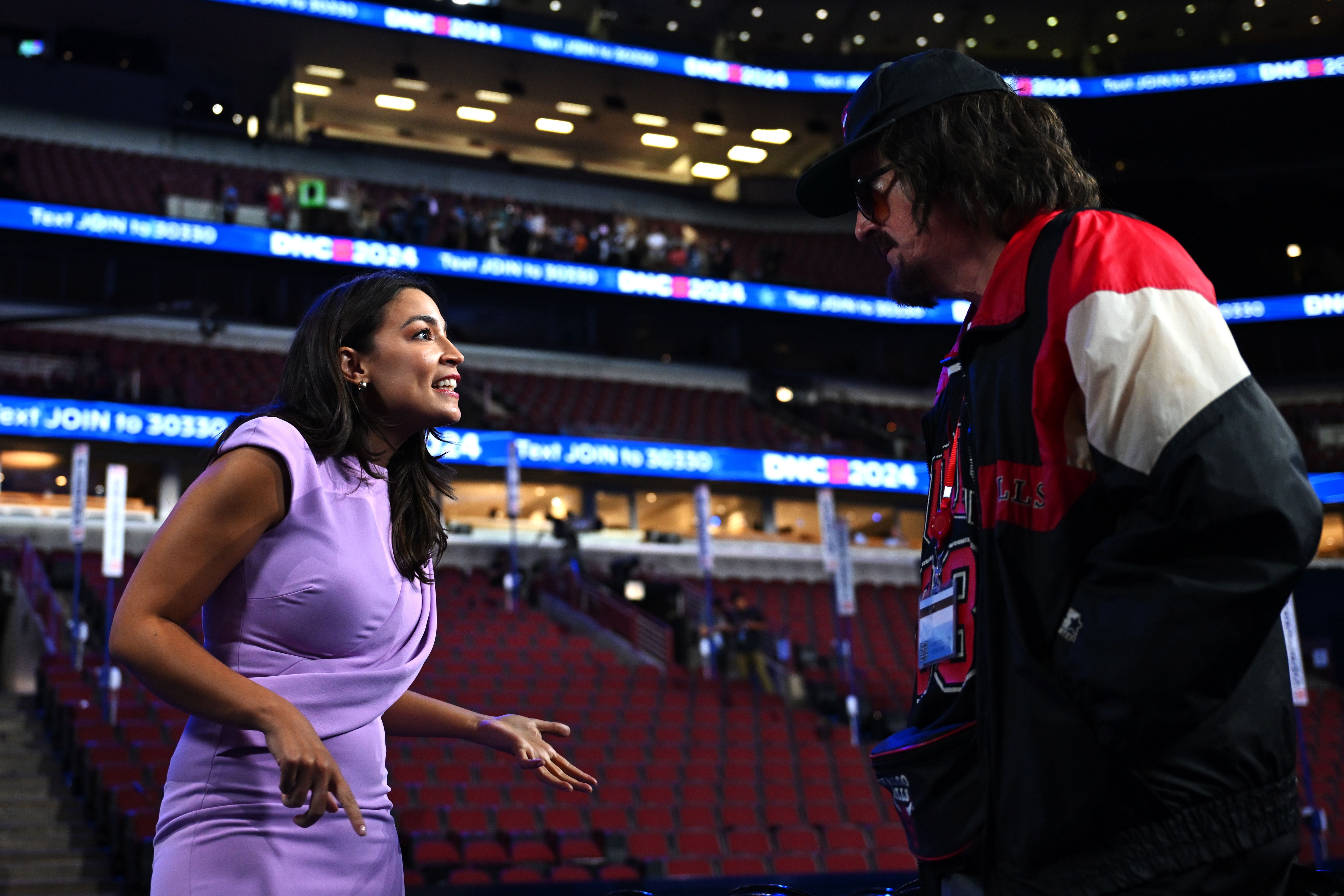 Stephen Colbert — in character as hot dog vendor Donny Franks — speaks with Rep. Alexandria Ocasio-Cortez (D-N.Y.) ahead of the DNC in Chicago on Sunday.