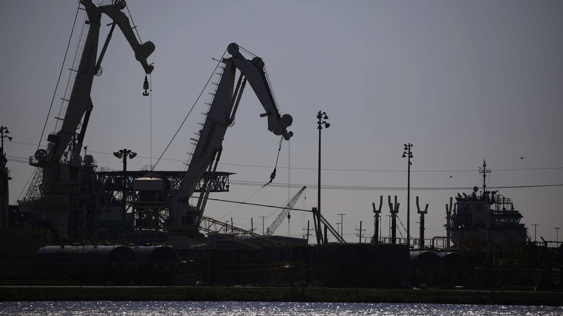 Cranes at an oil industry support facility in Port Fourchon, Louisiana, U.S., on Wednesday, April 21, 2021.