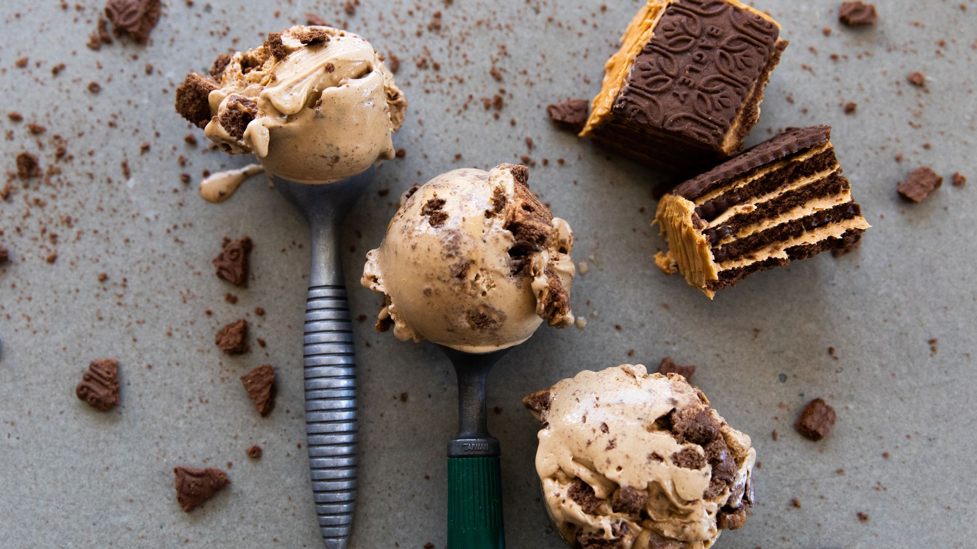 Three ice cream scoops with ice cream in them