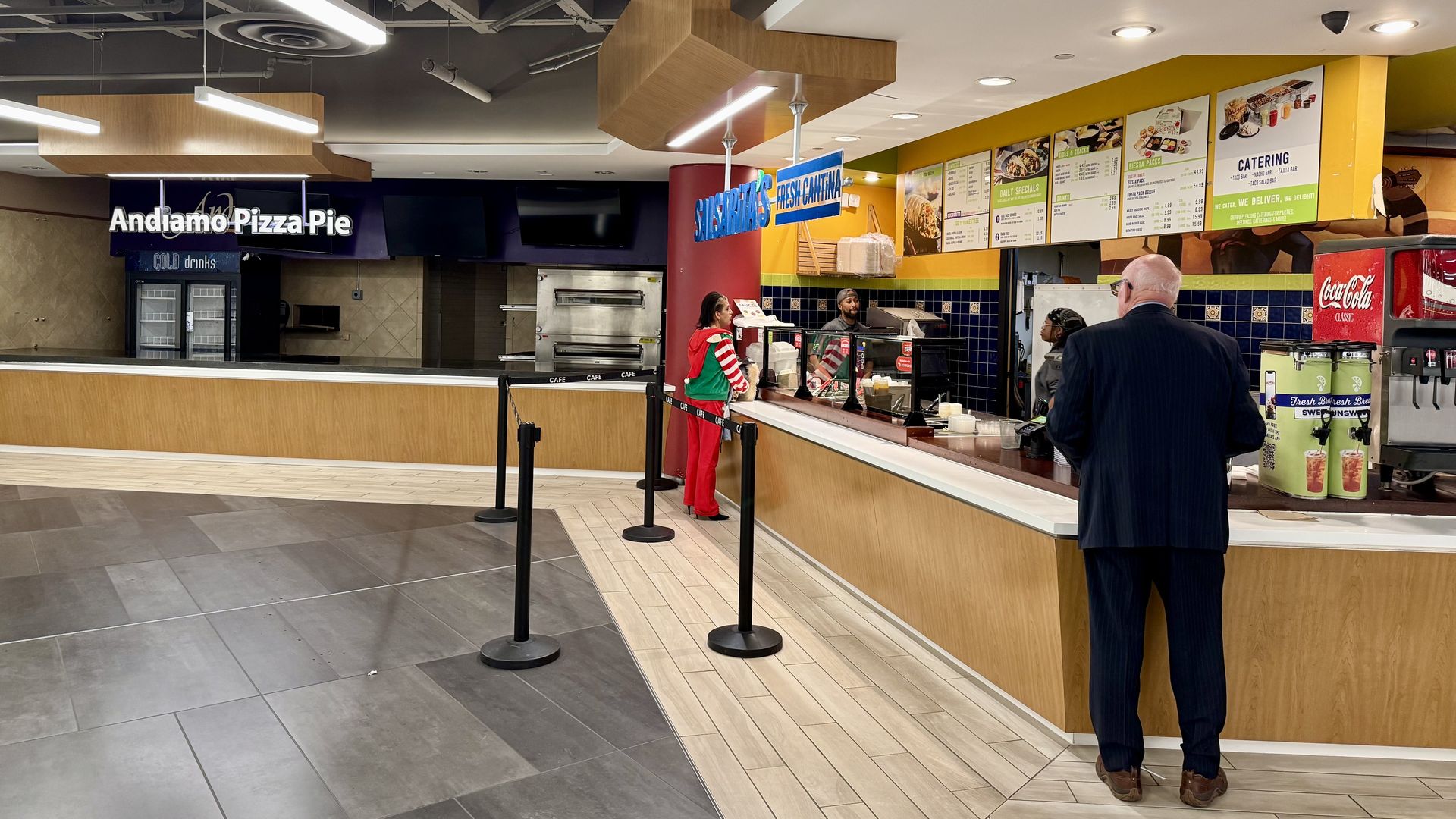 Salsarita's is pictured with a couple people in front. A closed food court stall next door.