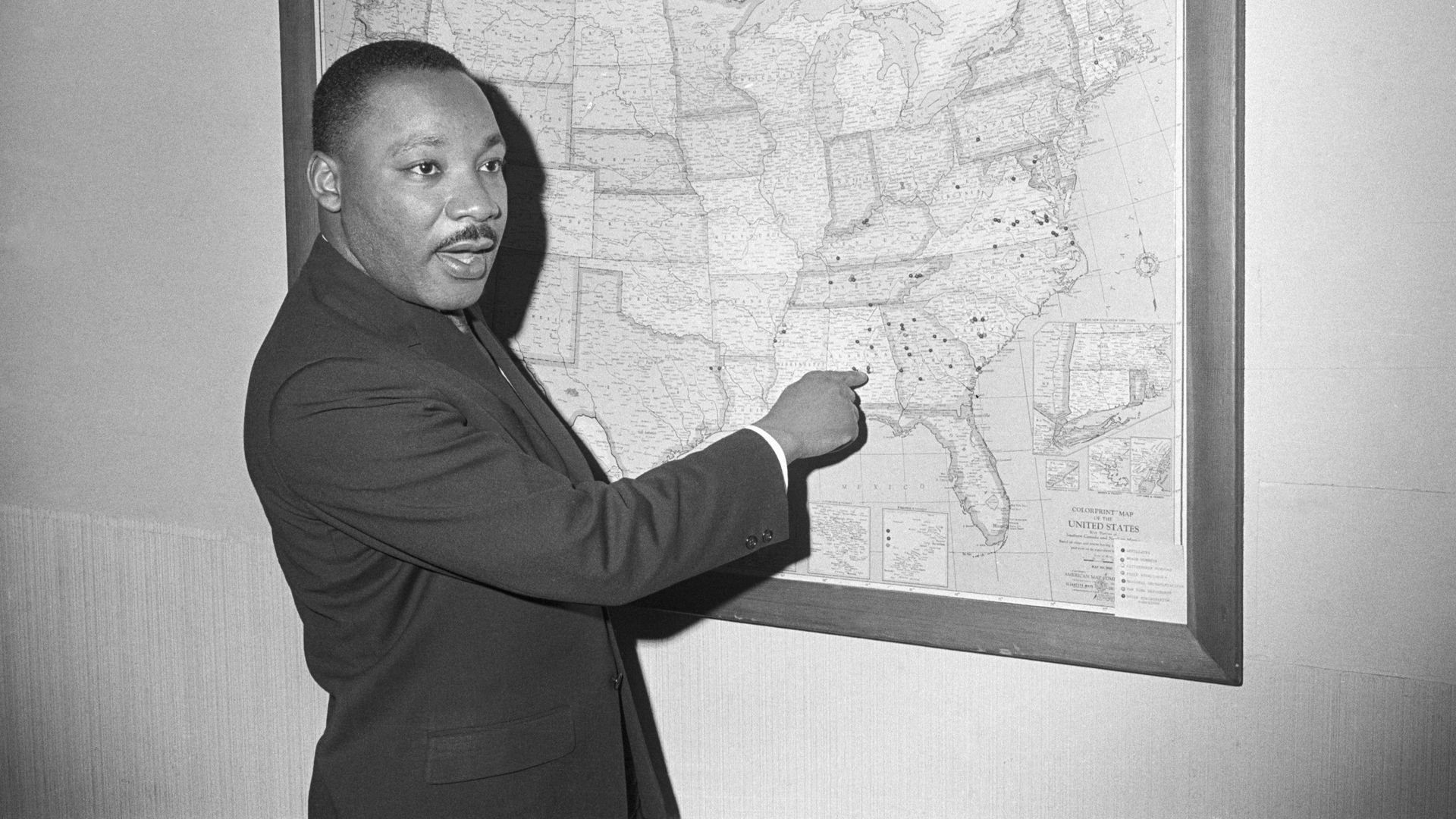 Martin Luther King, Jr, points to Selma, Alabama, on a map at his Atlanta Southern Christian Leadership Conference office in January 1965.