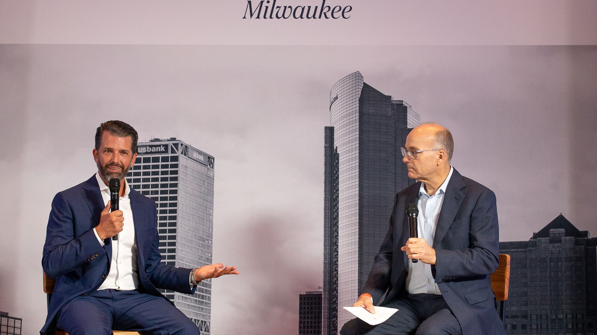 Photo of Donald Trump Jr. and Mike Allen on stage. 