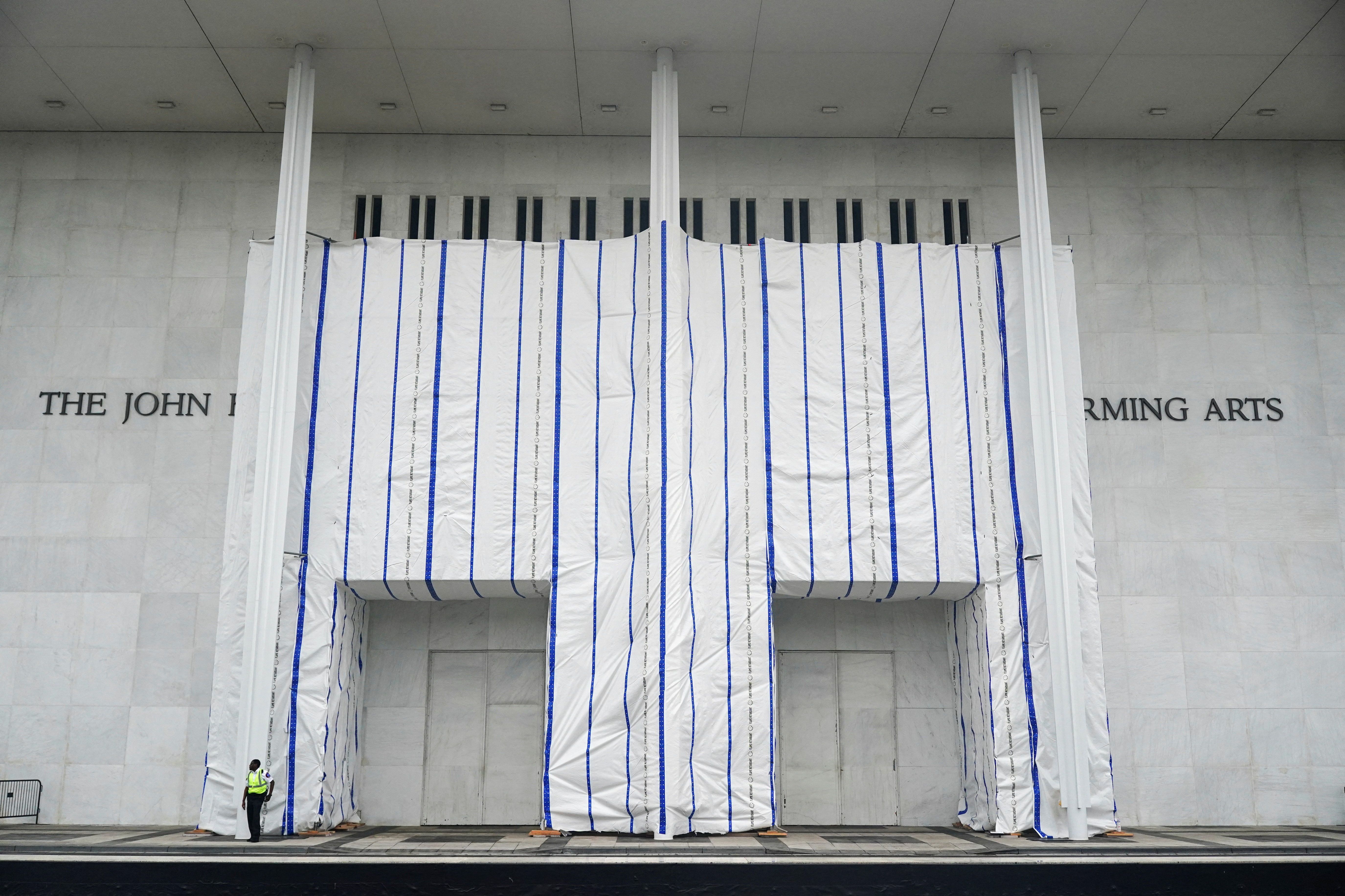 A tarp covers the facade of the John F. Kennedy Memorial Center for the Performing Arts, following a federal judge's order to remove U.S. President Donald Trump's name from the institution, on the day comedian Bill Maher receives the Mark Twain Prize for American Humor at the Kennedy Center, in Wash