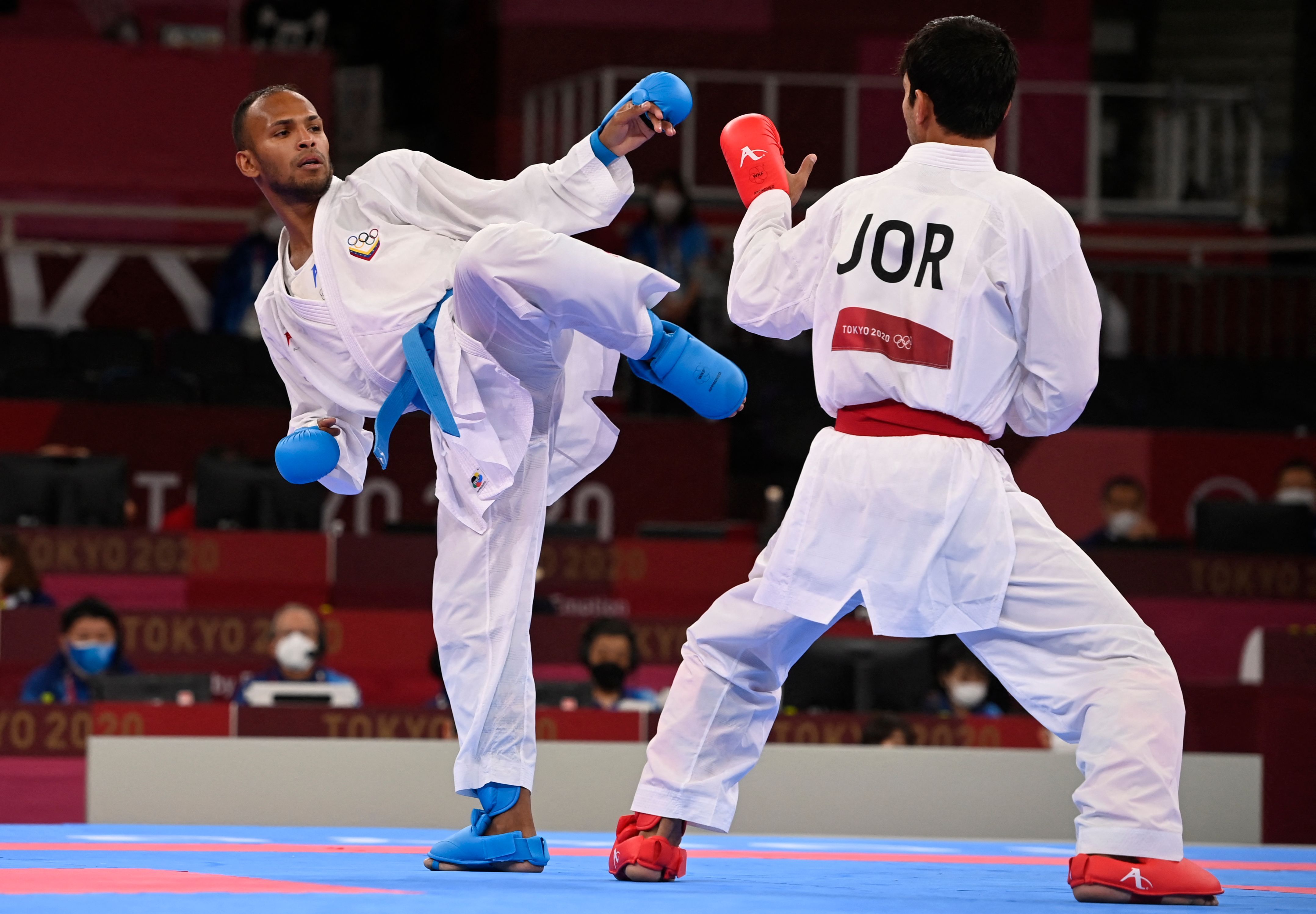 Jordan's Abdel Rahman Almasatfa (R) competes against Venezuela's Andres Eduardo Madera Delgado in the men's kumite -67kg elimination round of the karate competition