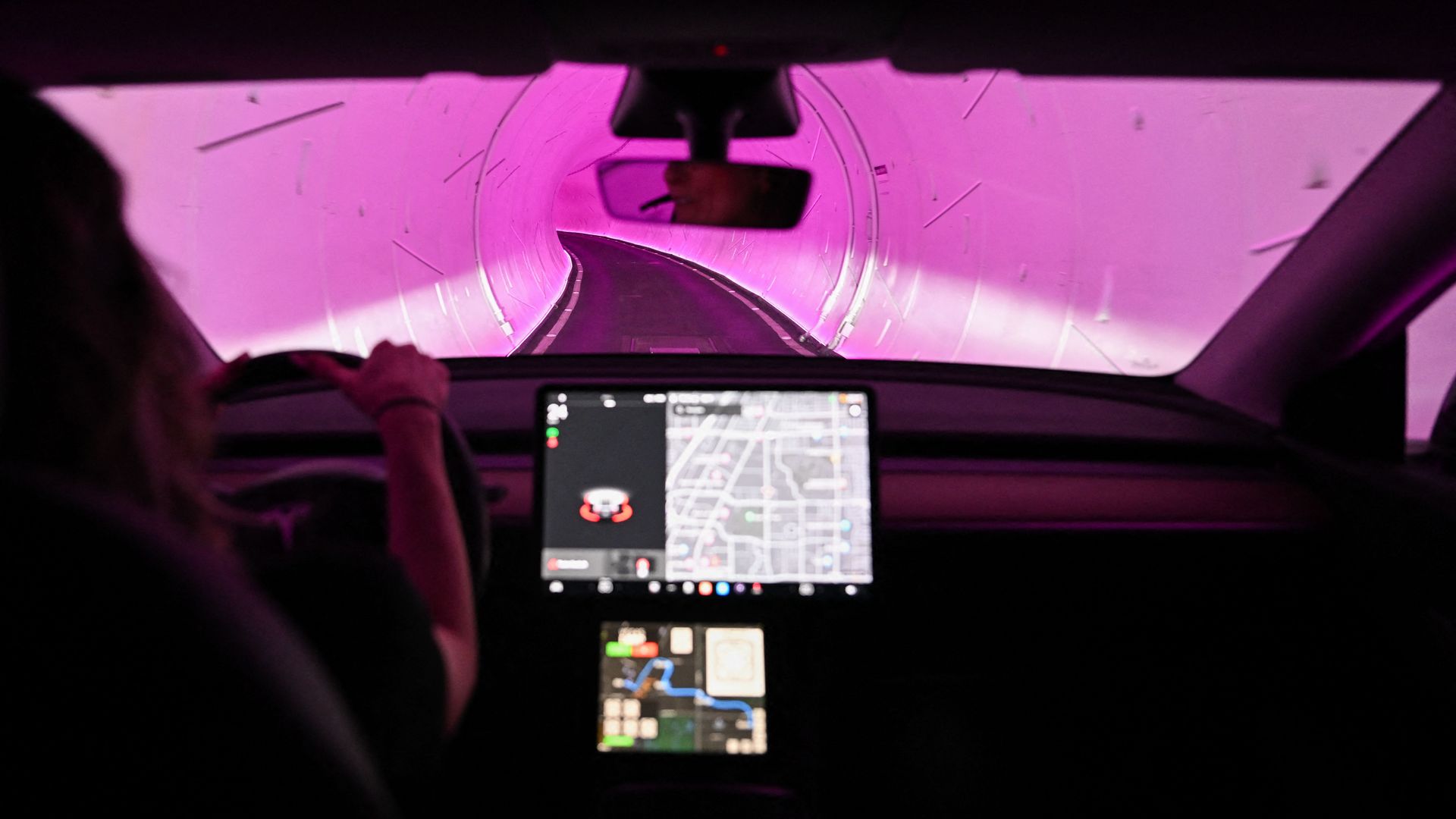 A Tesla Inc. electric vehicle is driven through a tunnel in the Boring Company's Las Vegas Convention Center Loop during the Consumer Electronics Show (CES) in Las Vegas, Nevada, on January 5, 2023.