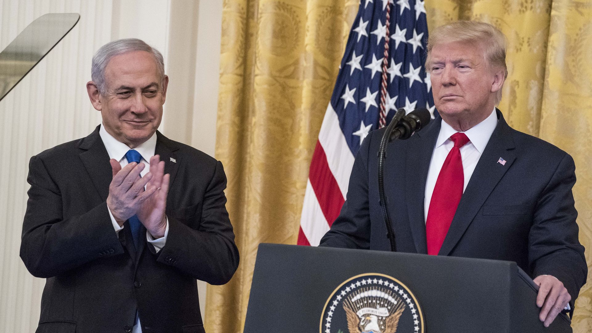 Israeli Prime Minister Benjamin Netanyahu claps as President Trump announces his Middle East peace plan