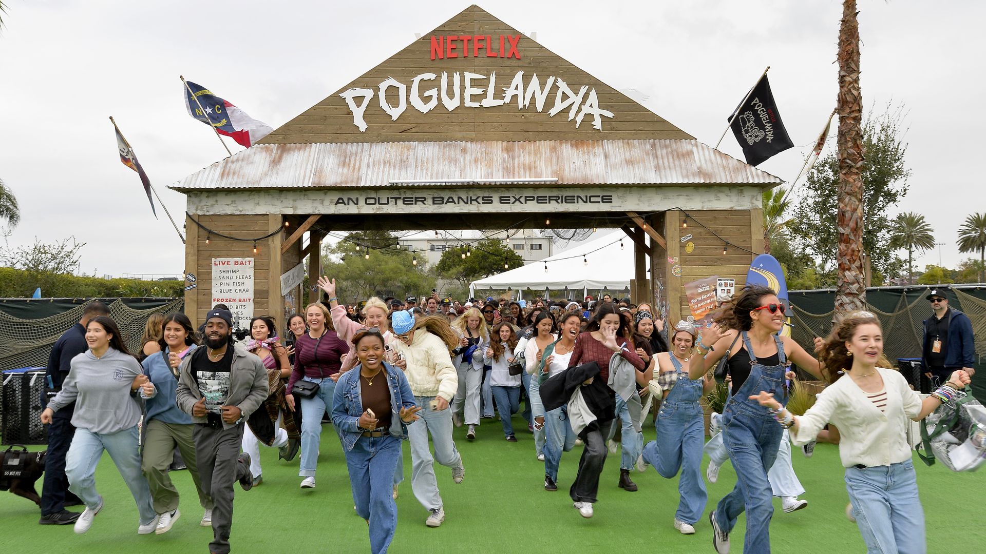 Fans running into the gates of "Poguelandia" - a festival for the Netflix show "Outer Banks"