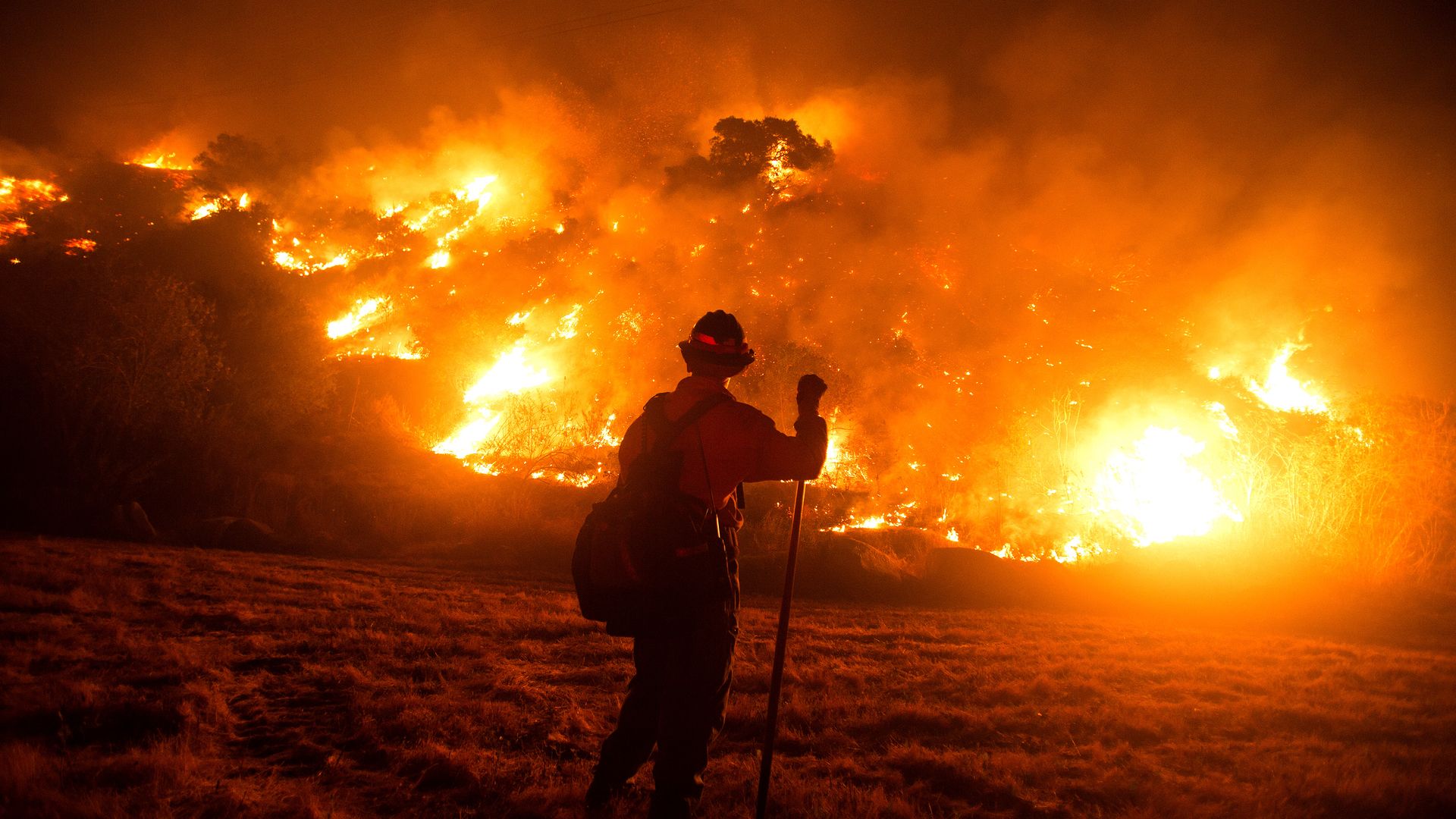 A firefighter works at the scene of the Bobcat Fire burning on hillsides near Monrovia Canyon Park in Monrovia, California on September 15